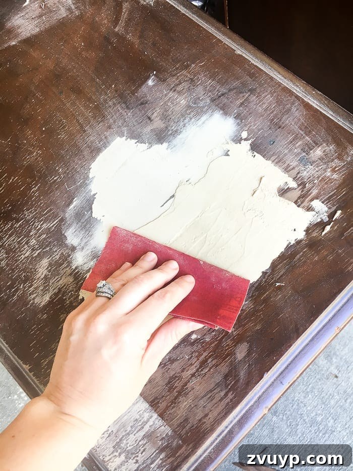 Gilded Glamour Nightstands 5 Sanding wood filler on a nightstand for a smooth finish