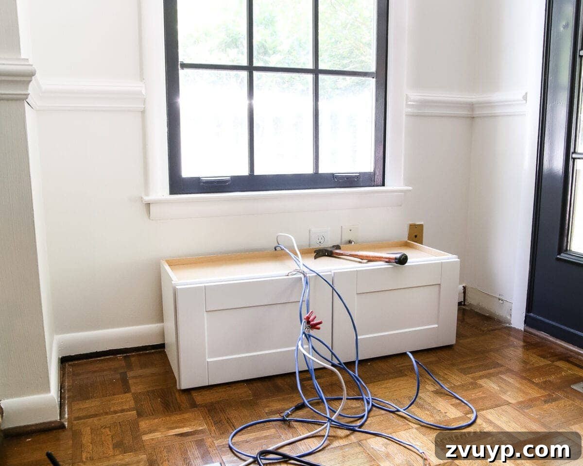 Kitchen Cabinet to Cozy Window Seat 3 DIY Window Seat from a Kitchen Cabinet | blesserhouse.com - A simplified tutorial for how to build a DIY window seat using a prefabbed kitchen cabinet to house electronics and hide cords.