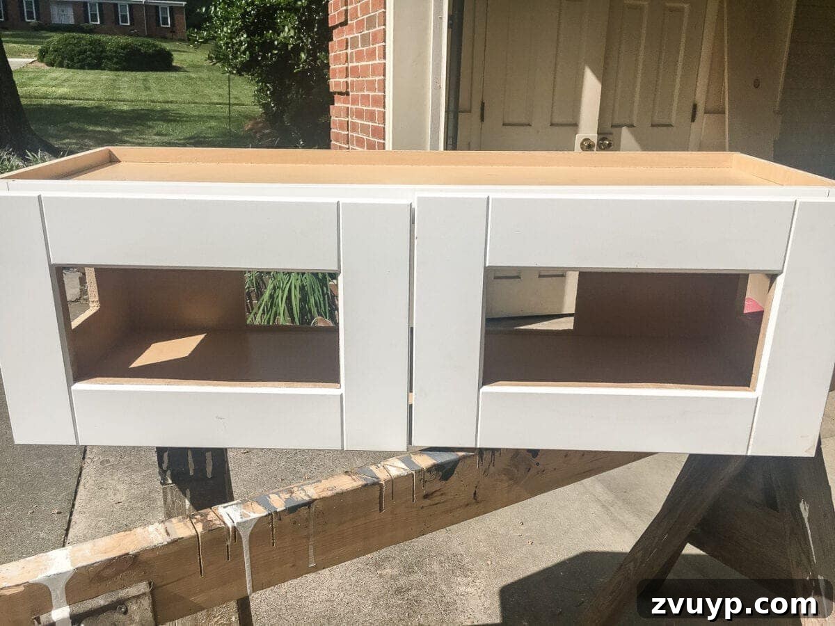 Kitchen Cabinet to Cozy Window Seat 8 DIY Window Seat from a Kitchen Cabinet | blesserhouse.com - A simplified tutorial for how to build a DIY window seat using a prefabbed kitchen cabinet to house electronics and hide cords.