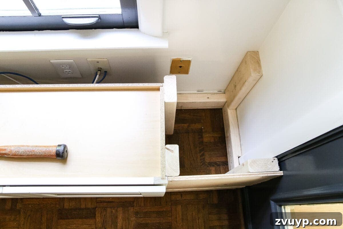Kitchen Cabinet to Cozy Window Seat 9 DIY Window Seat from a Kitchen Cabinet | blesserhouse.com - A simplified tutorial for how to build a DIY window seat using a prefabbed kitchen cabinet to house electronics and hide cords.