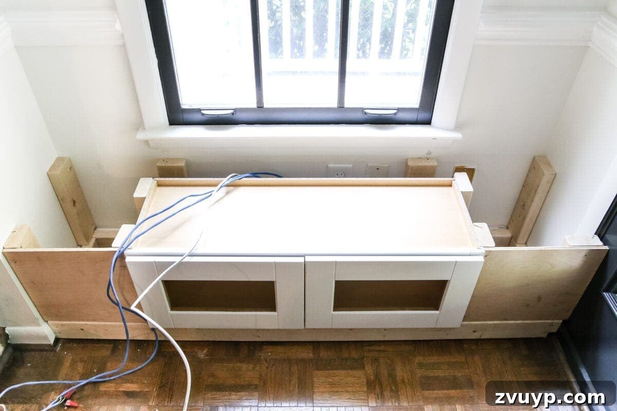 Kitchen Cabinet to Cozy Window Seat 10 DIY Window Seat from a Kitchen Cabinet | blesserhouse.com - A simplified tutorial for how to build a DIY window seat using a prefabbed kitchen cabinet to house electronics and hide cords.