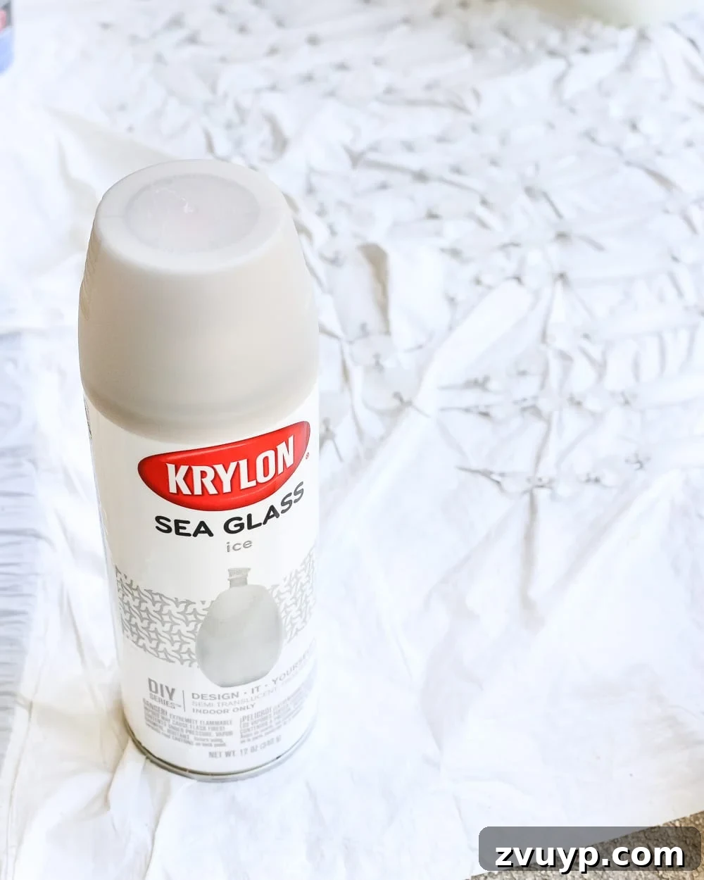 Regal Radiance Antique Gold Crystal Fixture Reimagined 10 Hand spraying Krylon Sea Glass Spray Paint in Gray onto the glass crystals to create a frosted, antique effect.