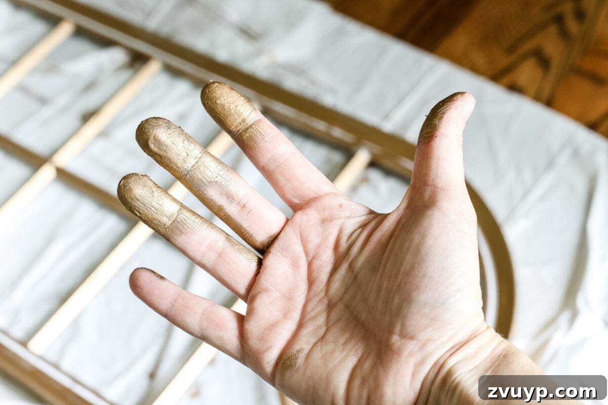 DIY Faux Aged Gold Antique Mirror Makeover 6 DIY Aged Gold Antique Mirror Makeover | Close-up of applying Rub 'n Buff to a mirror frame for a vintage gold look.