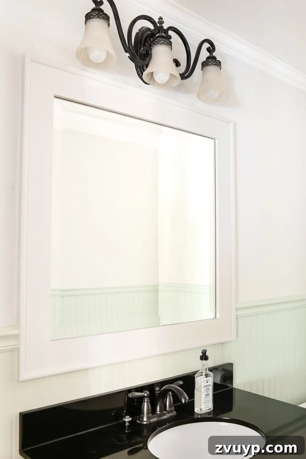 Dry Brush Black Mirror Redefined 2 Dry Brushed Black Mirror Makeover Tutorial | Transform a plain bathroom mirror with a dramatic, weathered finish using black and white paint, highlighting wood grain for an industrial farmhouse look.