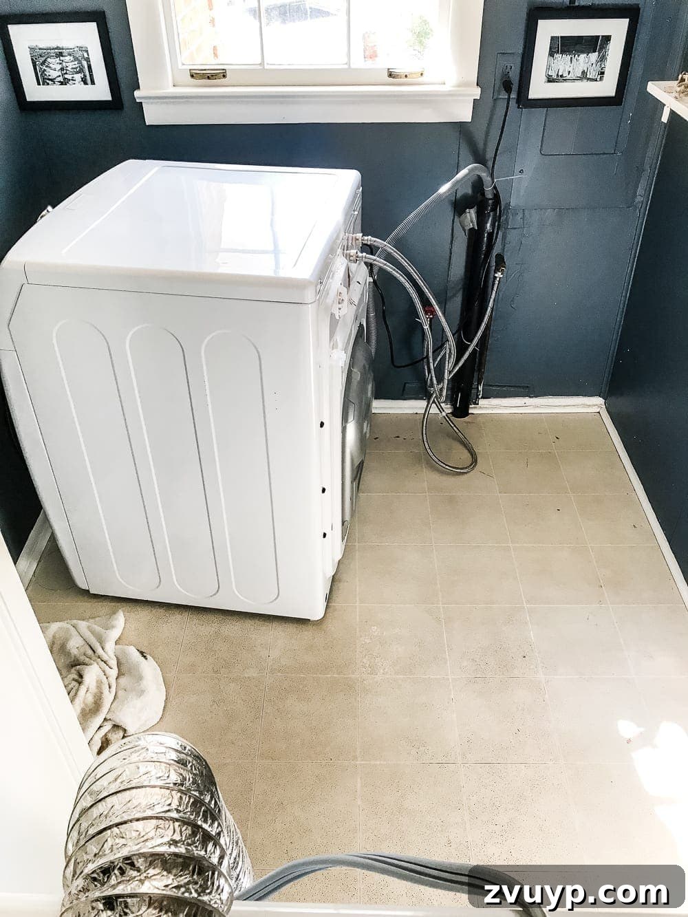 Moroccan Vinyl Tile Floor DIY 4 Before shot of an old, worn vinyl floor in a laundry room, demonstrating the need for a DIY upgrade with peel and stick tiles.
