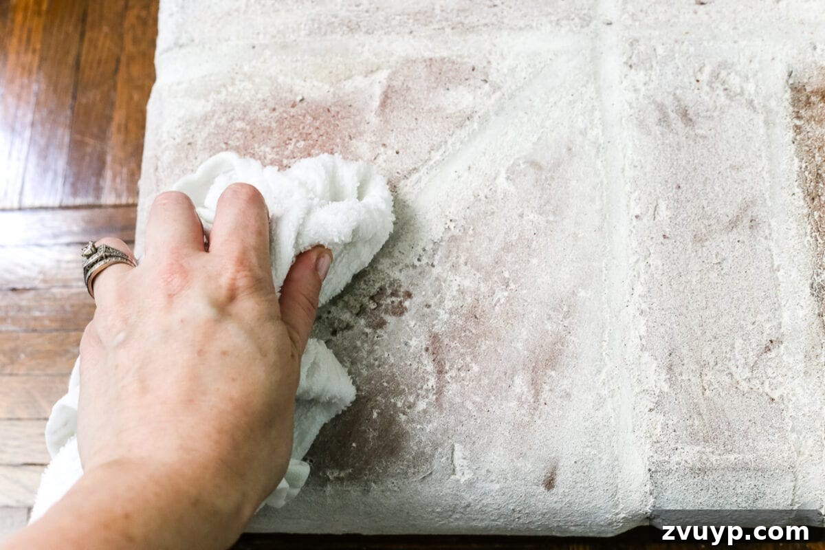 removing lime wash from bricks on a fireplace to distress