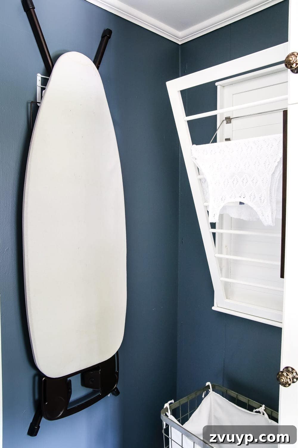 7 Brilliant Laundry Room Organizing Hacks 9 Wall-Mounted Ironing Board Hook for Space-Saving Laundry Room Storage