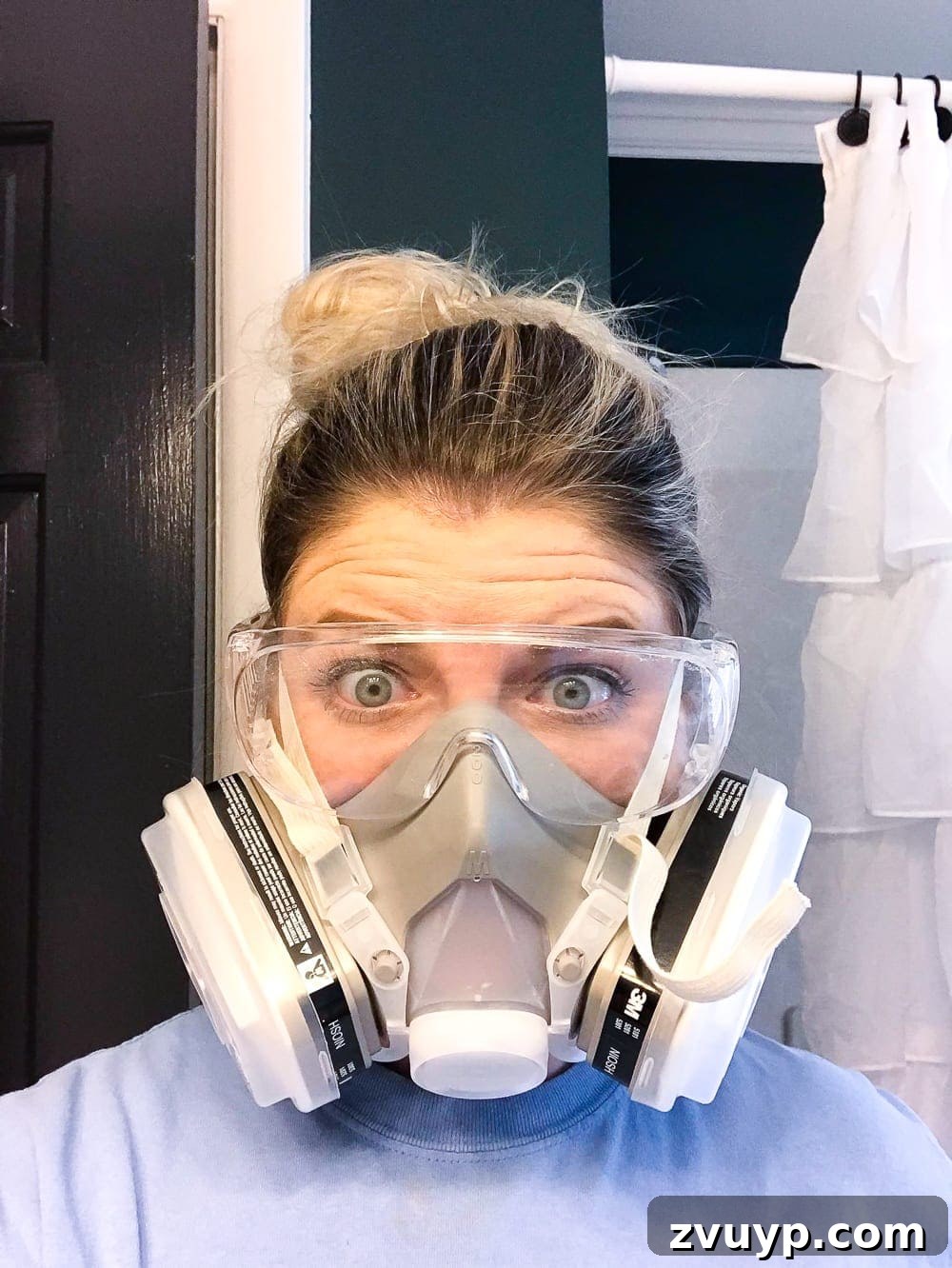 Painted Bathroom Countertop Revival 13 Wearing a respirator mask for safety while preparing to paint a countertop