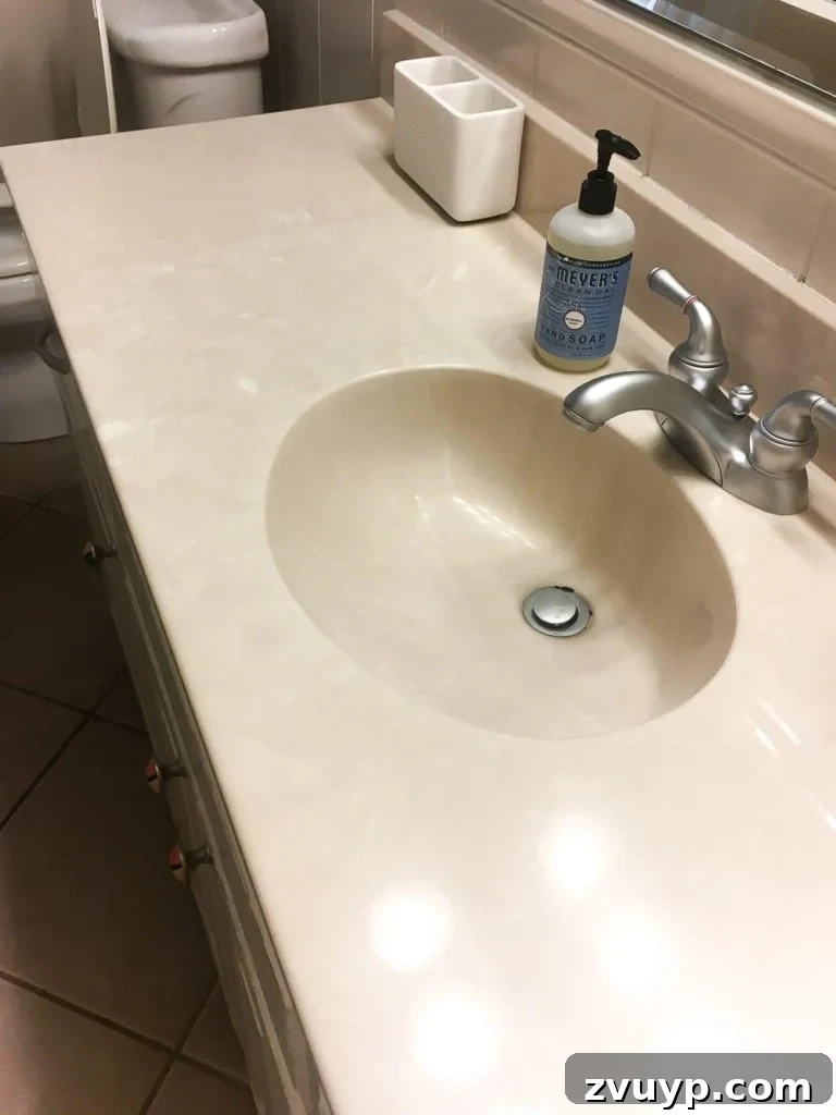Painted Bathroom Countertop Revival 3 Before photo of a bathroom with an old beige sink and countertop