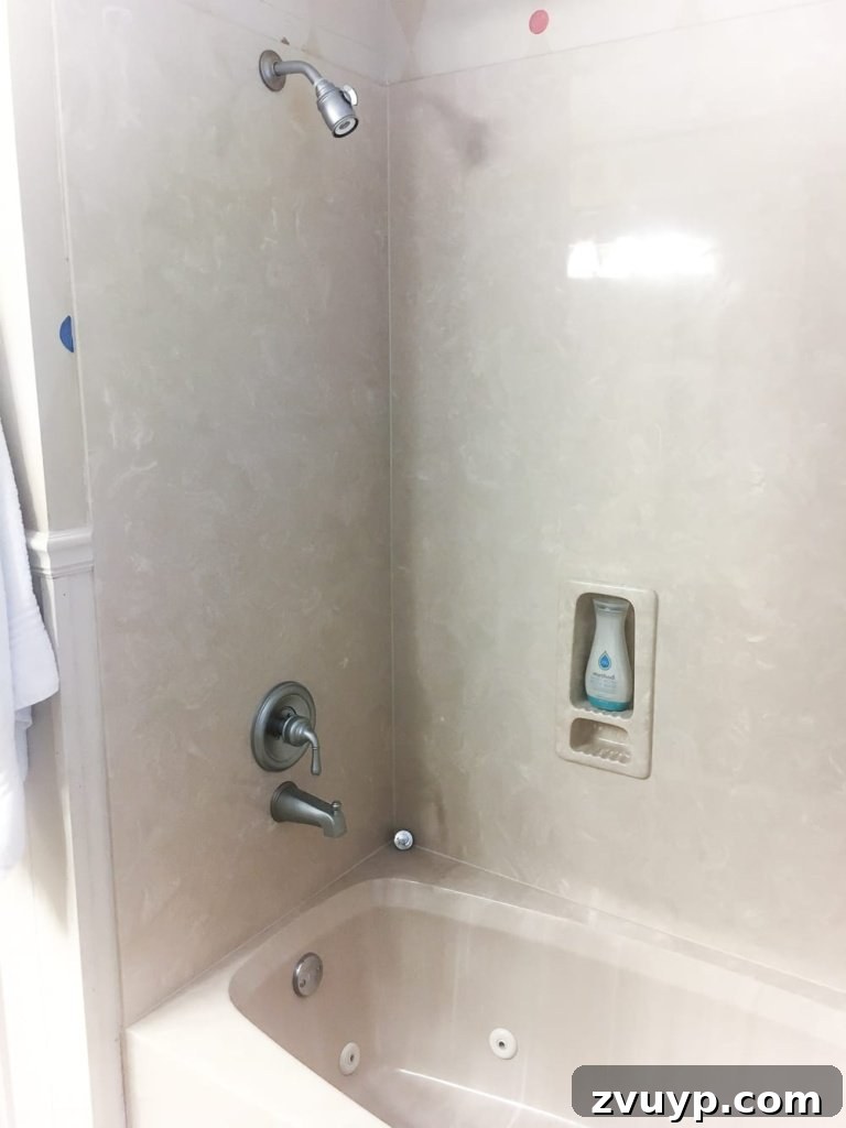 Painted Bathroom Countertop Revival 6 Before shot of a beige tub and shower combo