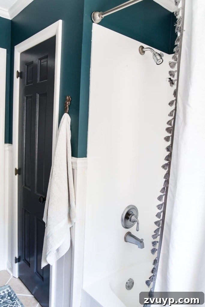 Painted Bathroom Countertop Revival 7 After photo of a bright white painted tub and shower