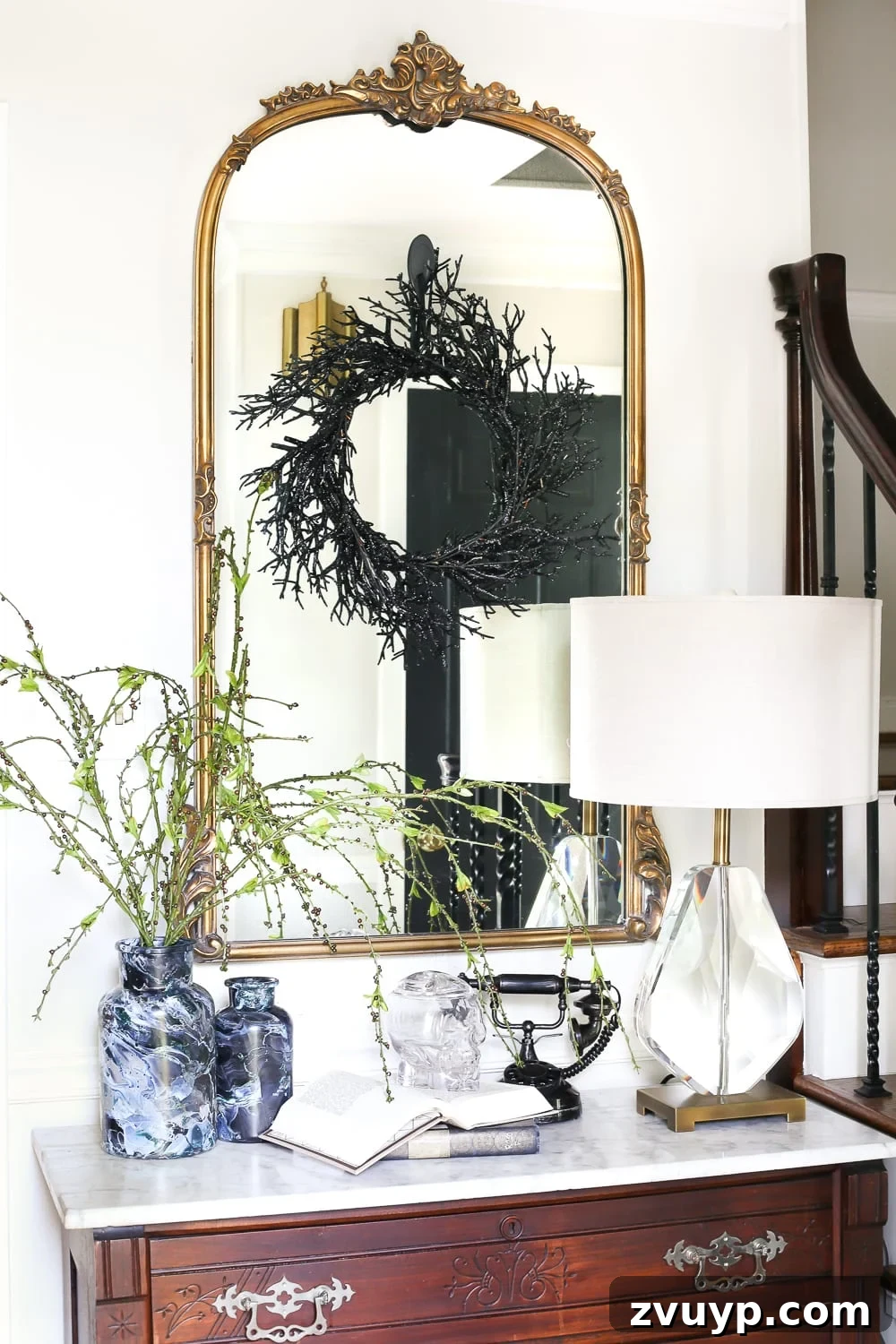Marbled Wonders for a Haunted Welcome 11 Marbled vase with willowy green branches, part of Halloween entryway decor