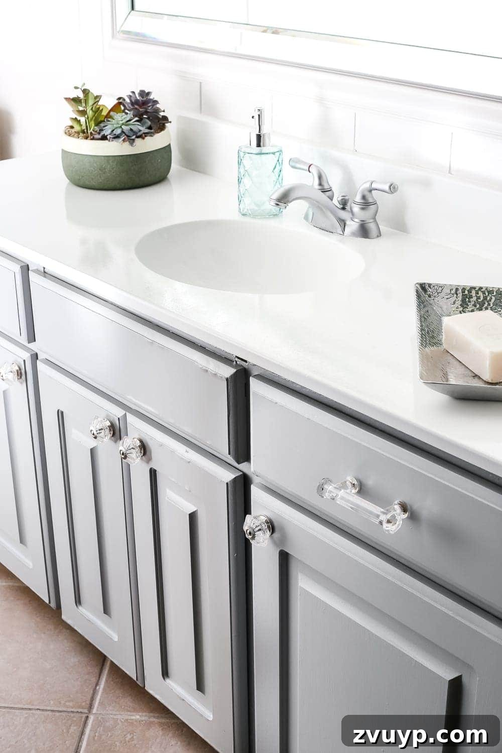 Elevate Your Bathroom with a Cabinet Paint Refresh 4 Benjamin Moore Coventry Gray painted bathroom vanity. Inexpensive bathroom update idea.