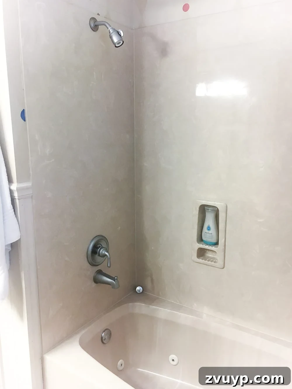 Kid Friendly and Guest Ready Bathroom Makeover 12 Before Bathroom Shower and Tub: Dated and beige shower/tub combo awaiting a budget-friendly painting transformation. #bathroomrenovation #oldfixtures #diyshower