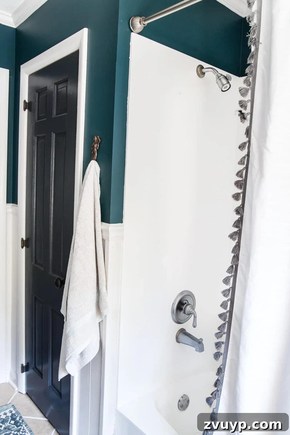 Kid Friendly and Guest Ready Bathroom Makeover 13 After Bathroom Shower and Tub: Beautifully refinished in bright white, creating a clean and modern bathing area. #paintedtub #showermakeover #bathroomupgrade