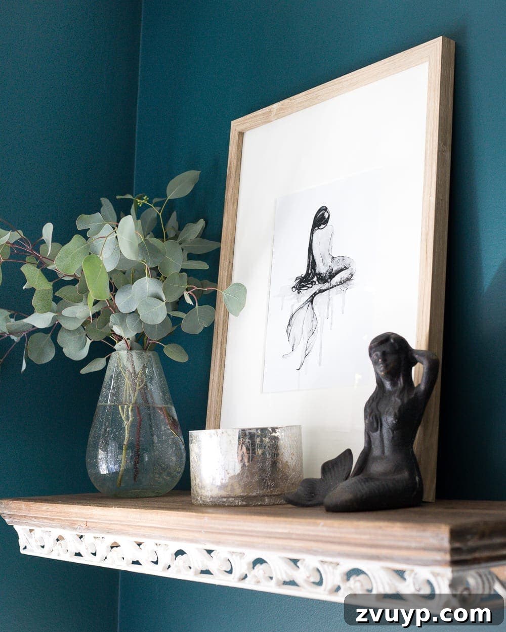 Kid Friendly and Guest Ready Bathroom Makeover 16 Mermaid Shelf Decor: Driftwood-look shelf holding a mermaid statuette and watercolor art, perfect for a subtle mermaid theme. #mermaidart #shelfdecor #kidsdecor