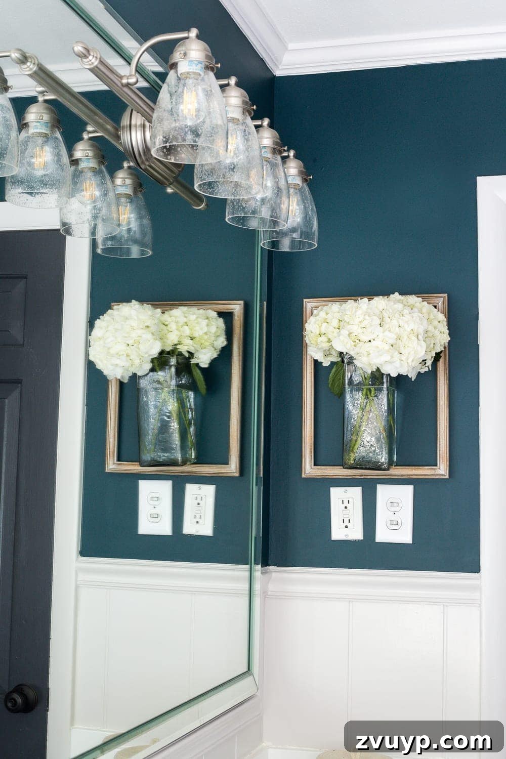 Kid Friendly and Guest Ready Bathroom Makeover 7 Close-up of Bathroom Door and Wainscoting: Black door in Benjamin Moore Wrought Iron, white wainscoting, and deep teal walls, creating a chic and modern contrast. #painteddoors #wainscoting #bathroomcolors