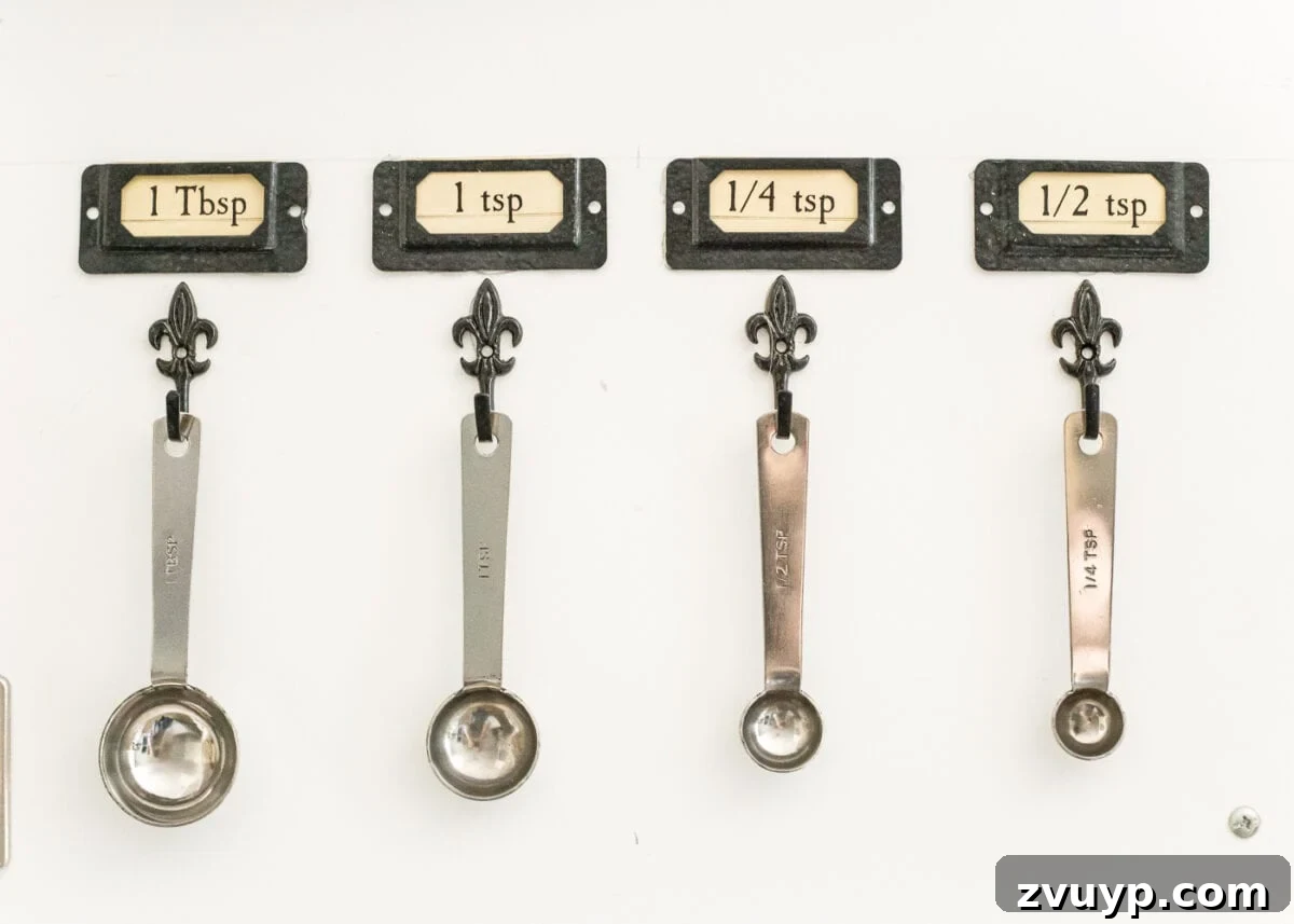 Pantry Perfection: Smart Organization & Custom Labels 5 Pantry Cabinet Organization and Free Printable Label Set | blesserhouse.com - A cabinet gets a drastic organization makeover using inexpensive IKEA jars / baskets, hanging storage, and a free pantry label printable set. #organization