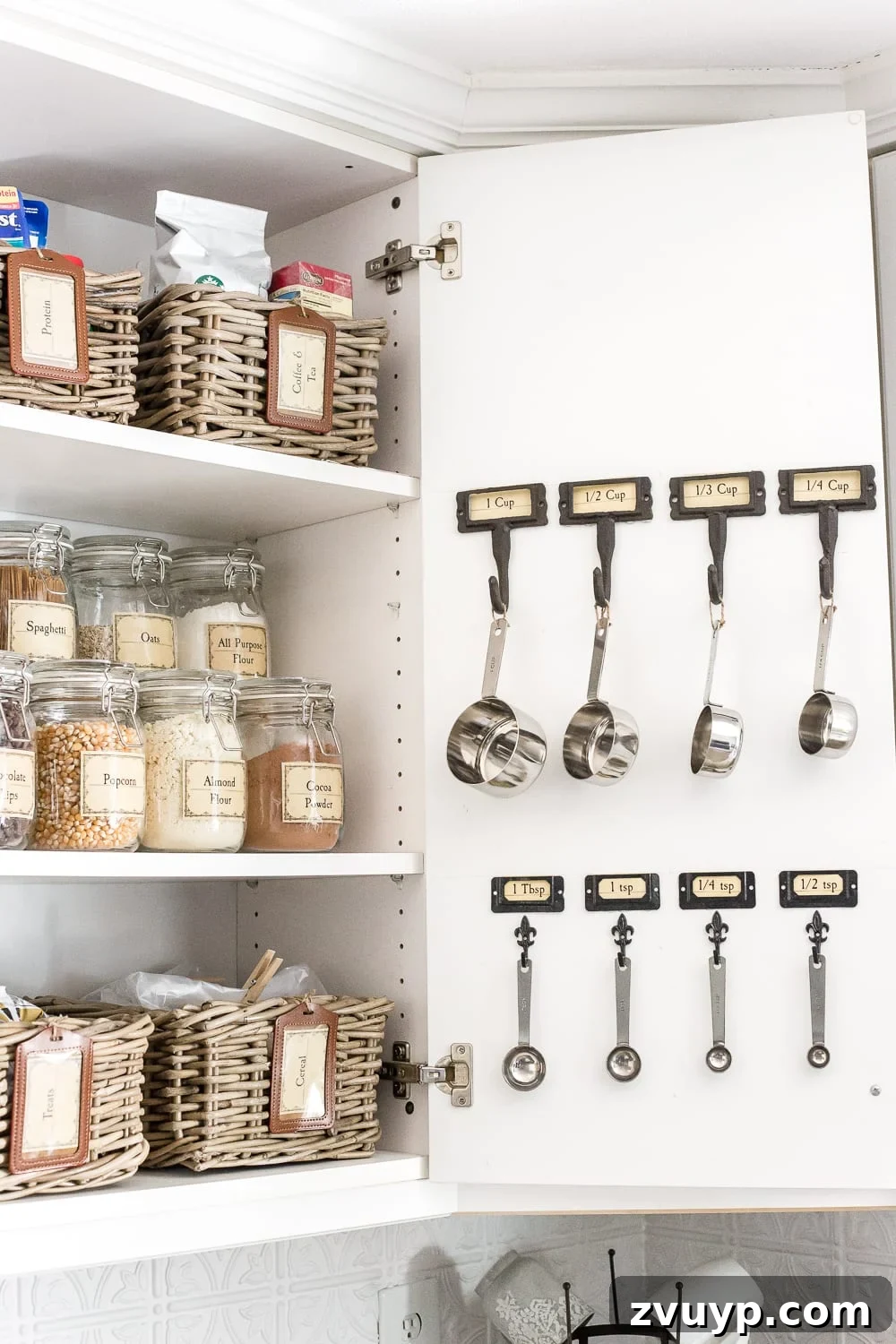 Pantry Perfection: Smart Organization & Custom Labels 6 Pantry Cabinet Organization and Free Printable Label Set | blesserhouse.com - A cabinet gets a drastic organization makeover using inexpensive IKEA jars / baskets, hanging storage, and a free pantry label printable set. #organization