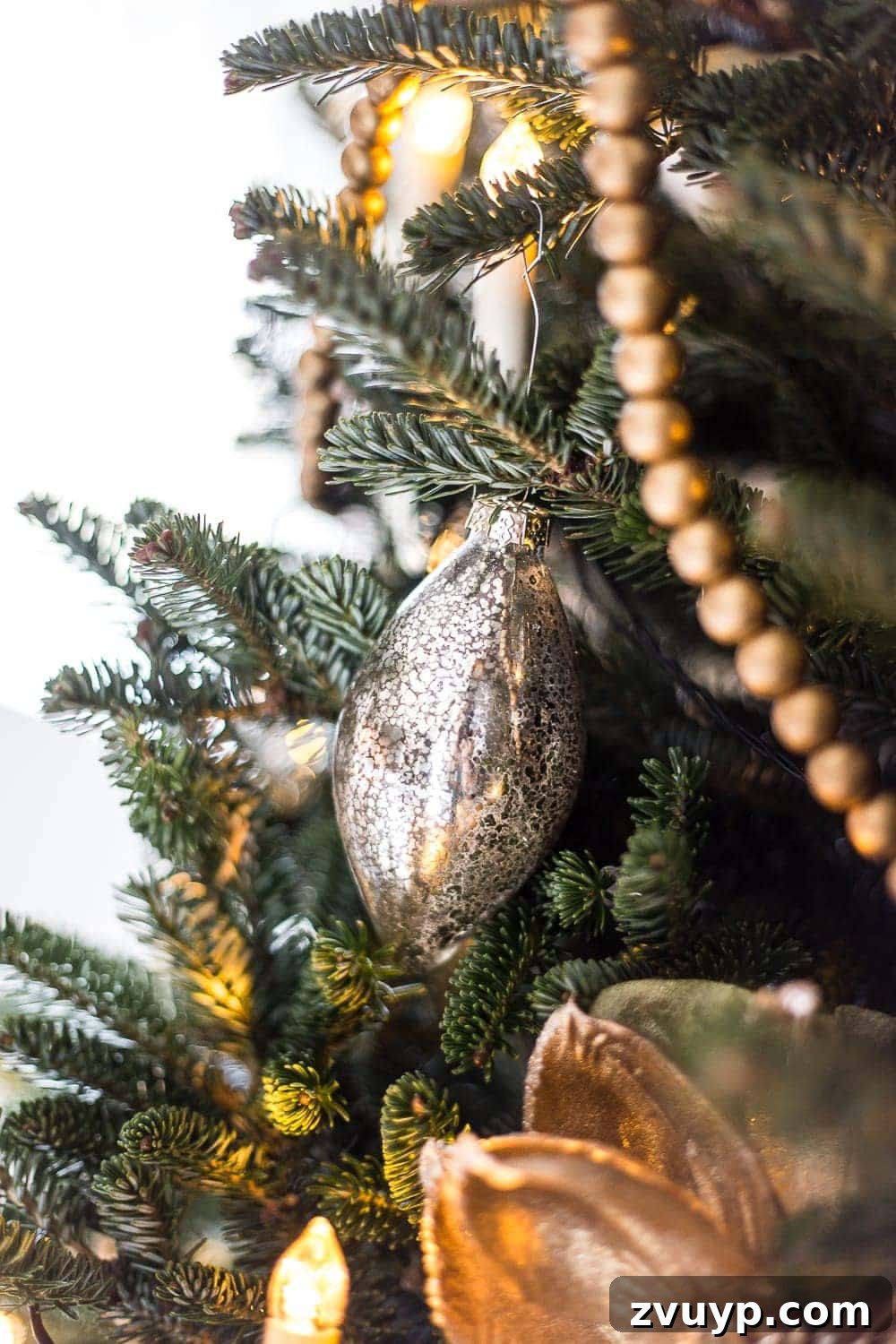 Craft Your Perfect Tree: A Step-by-Step Real Christmas Tree Decorating Guide 10 mercury glass ornament on a tree branch