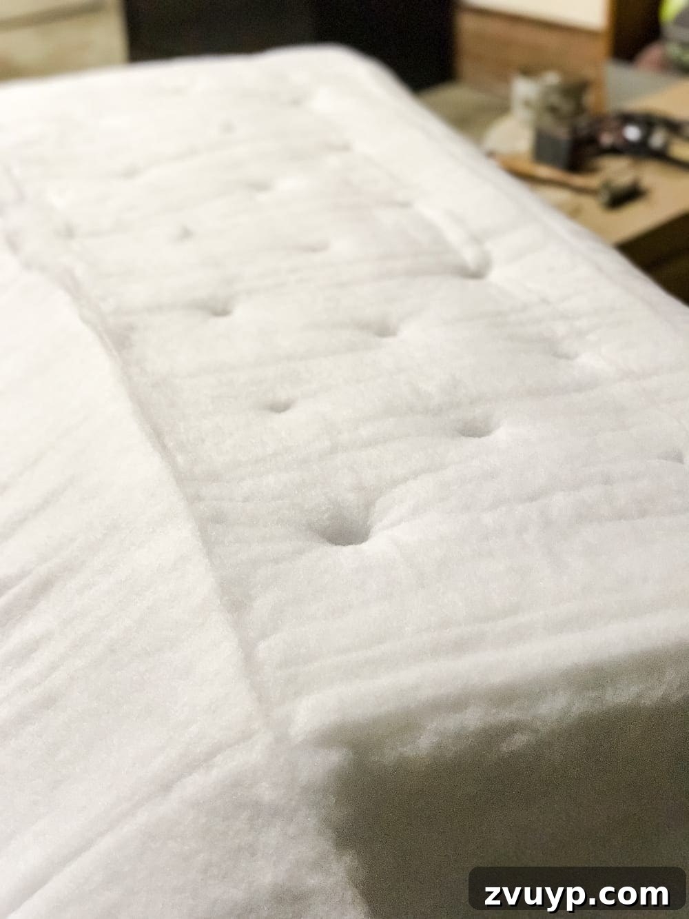 From Coffee Table to Ottoman An Easy DIY Transformation 19 Placing Batting and Aligning Holes for Tufting