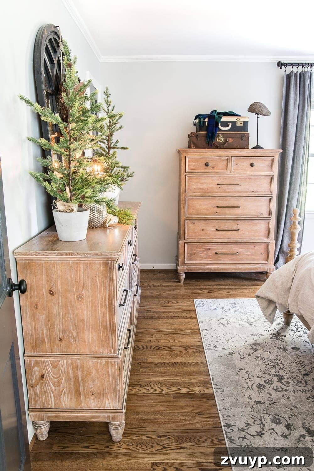 Cozy Blue and Neutral Christmas Sanctuary 13 Small Master Bedroom Decorated for Christmas and Winter with Wood Furniture | blesserhouse.com - An intimate view of a cozy master bedroom, showcasing wood furniture, blue and neutral decor, and subtle Christmas touches that extend through winter.