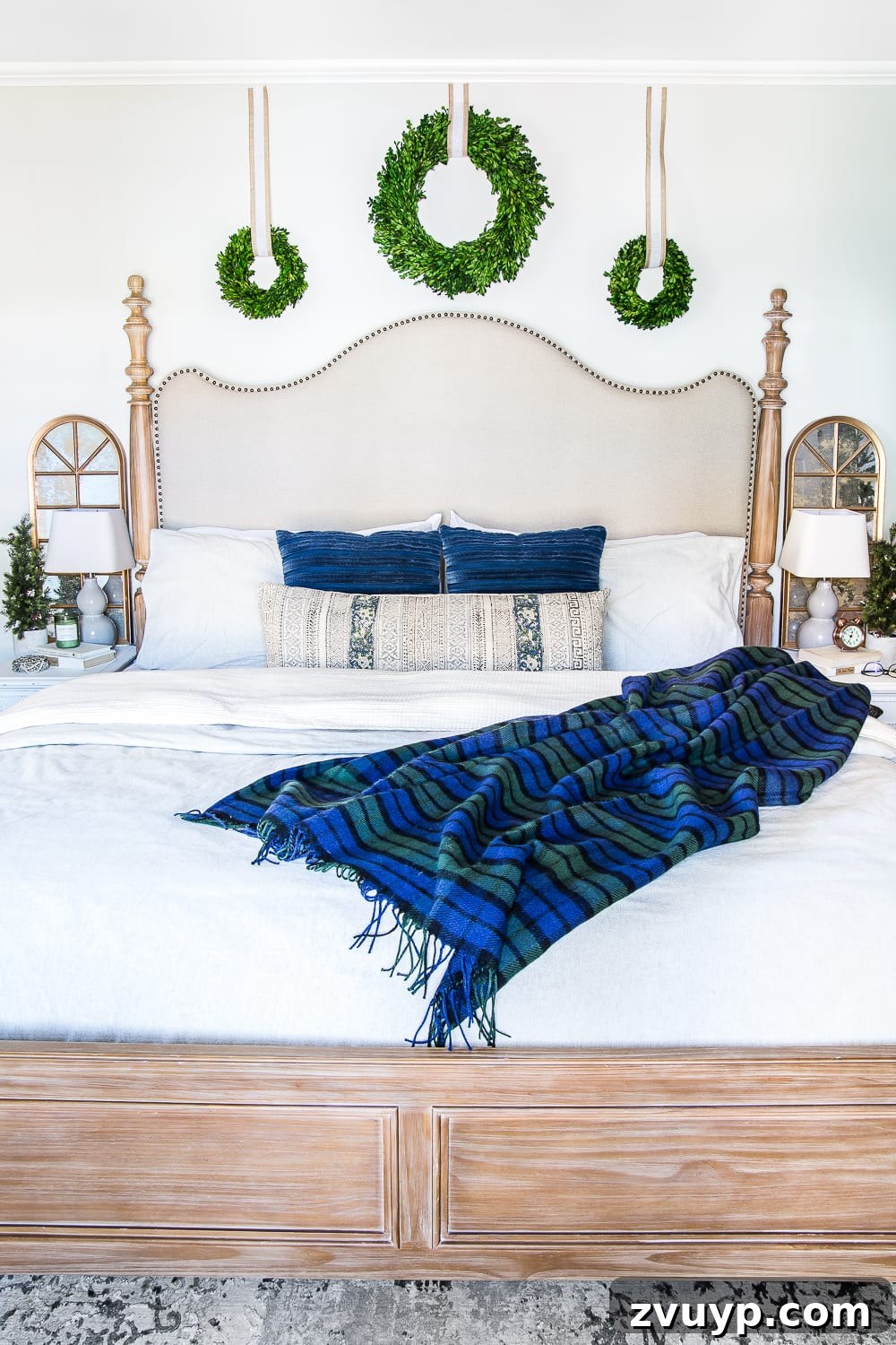 Cozy Blue and Neutral Christmas Sanctuary 4 Master Bedroom with Blue Christmas Decor and Natural Greenery | blesserhouse.com - A cozy bedroom featuring blue accents, neutral tones, and green boxwood wreaths, designed for both Christmas and winter.