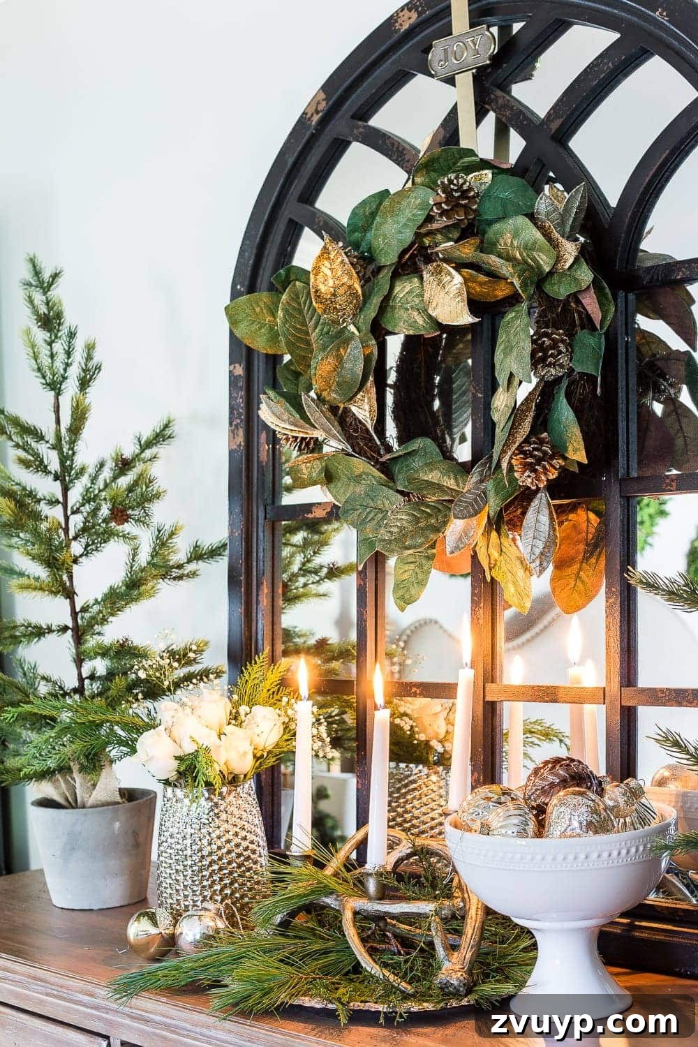Cozy Blue and Neutral Christmas Sanctuary 10 Close-up of Magnolia Wreath and Pedestal Bowl in Christmas Bedroom | blesserhouse.com - A detailed view of a magnolia wreath and a white pedestal bowl on a dresser, reflecting a timeless Christmas and winter aesthetic.