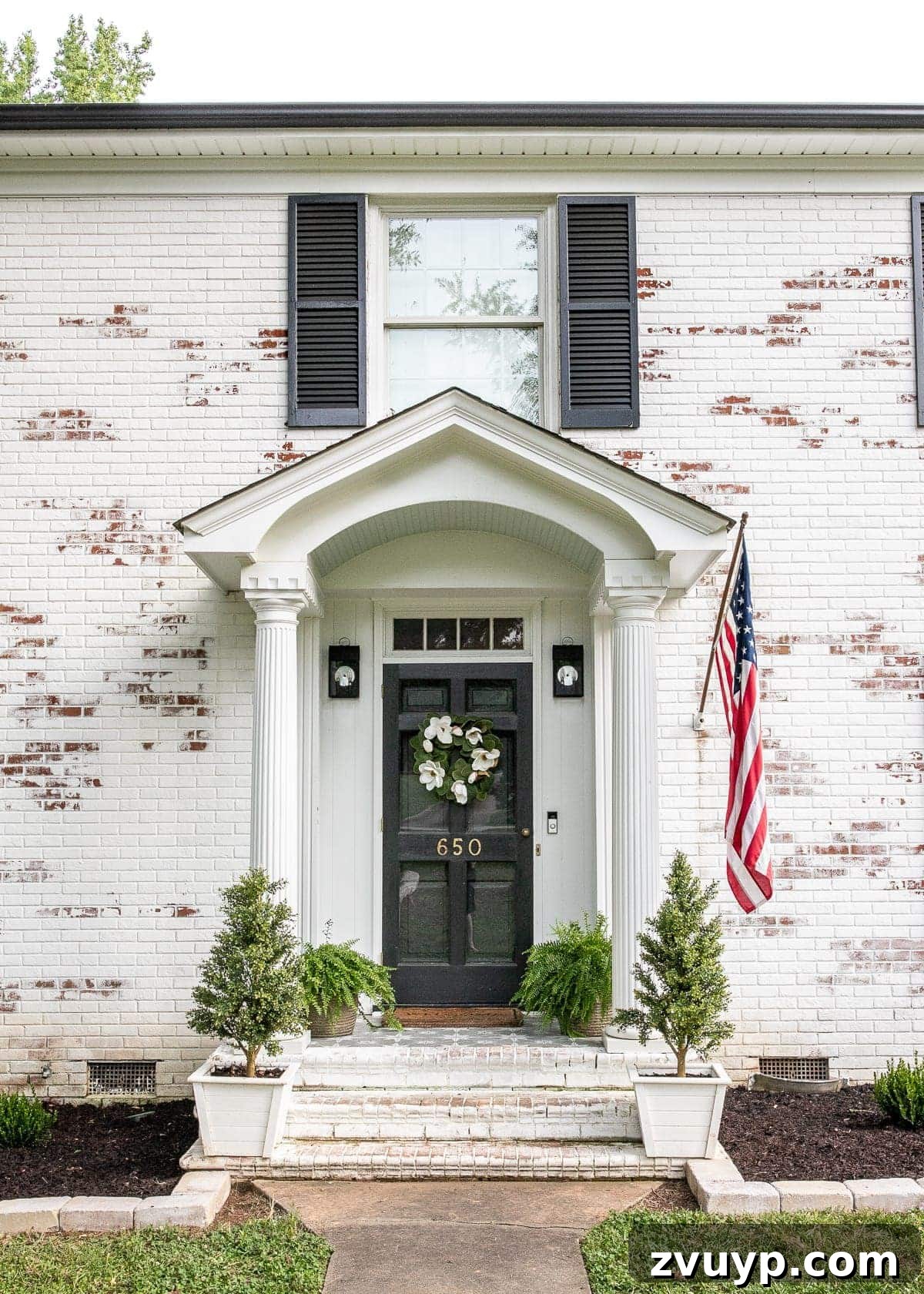 Limewash Magic: Our Brick Exterior Transformed 15 Stenciled front porch with stone outlined flower beds complementing limewashed brick