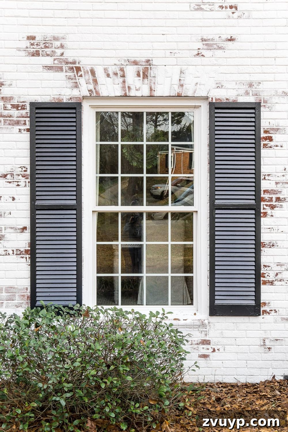 Limewash Magic: Our Brick Exterior Transformed 16 Limewashed brick around window with new black shutters