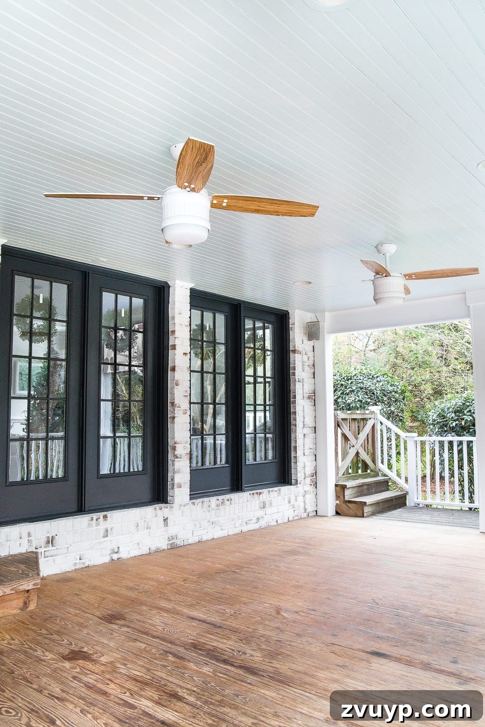 Limewash Magic: Our Brick Exterior Transformed 27 Limewashed brick with black French doors and a haint blue porch ceiling