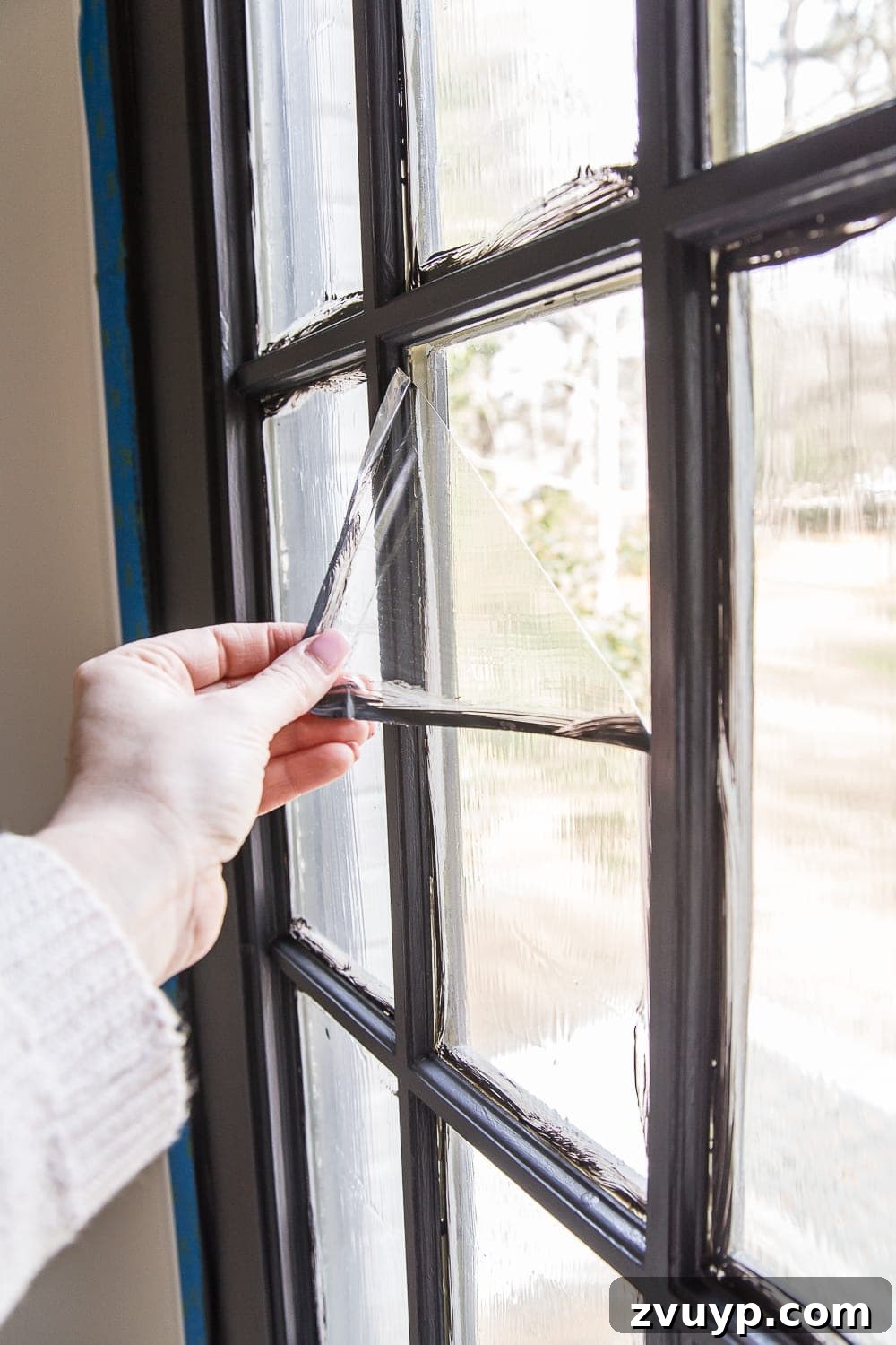 DIY French Door Painting Tips and Replacement Cost Breakdown 14 peeling masking liquid away from a french door window pane