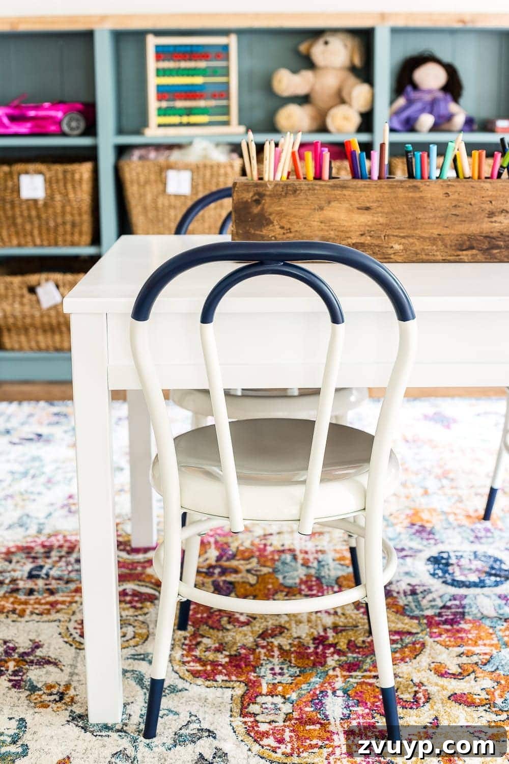 Playroom Glow Up: Fresh Lights and Furnishings 6 A white adjustable play table in a playroom, featuring its versatile design for growing children and creative activities.