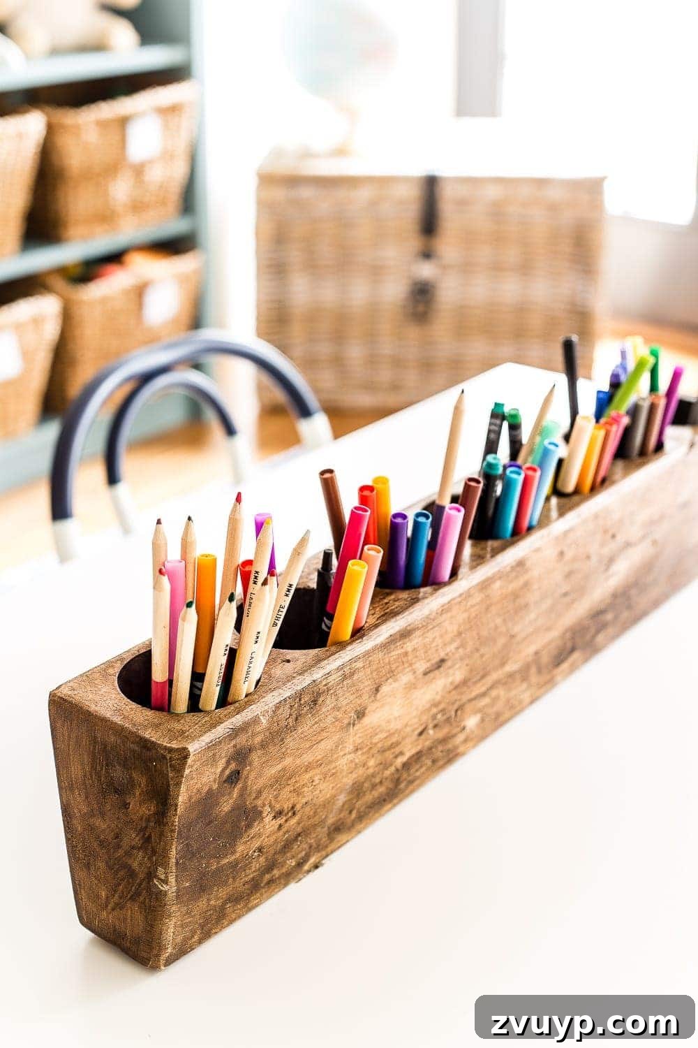 Playroom Glow Up: Fresh Lights and Furnishings 8 An antique sugar mold repurposed as an organizer for markers and colored pencils on a playroom table, blending vintage and modern decor.