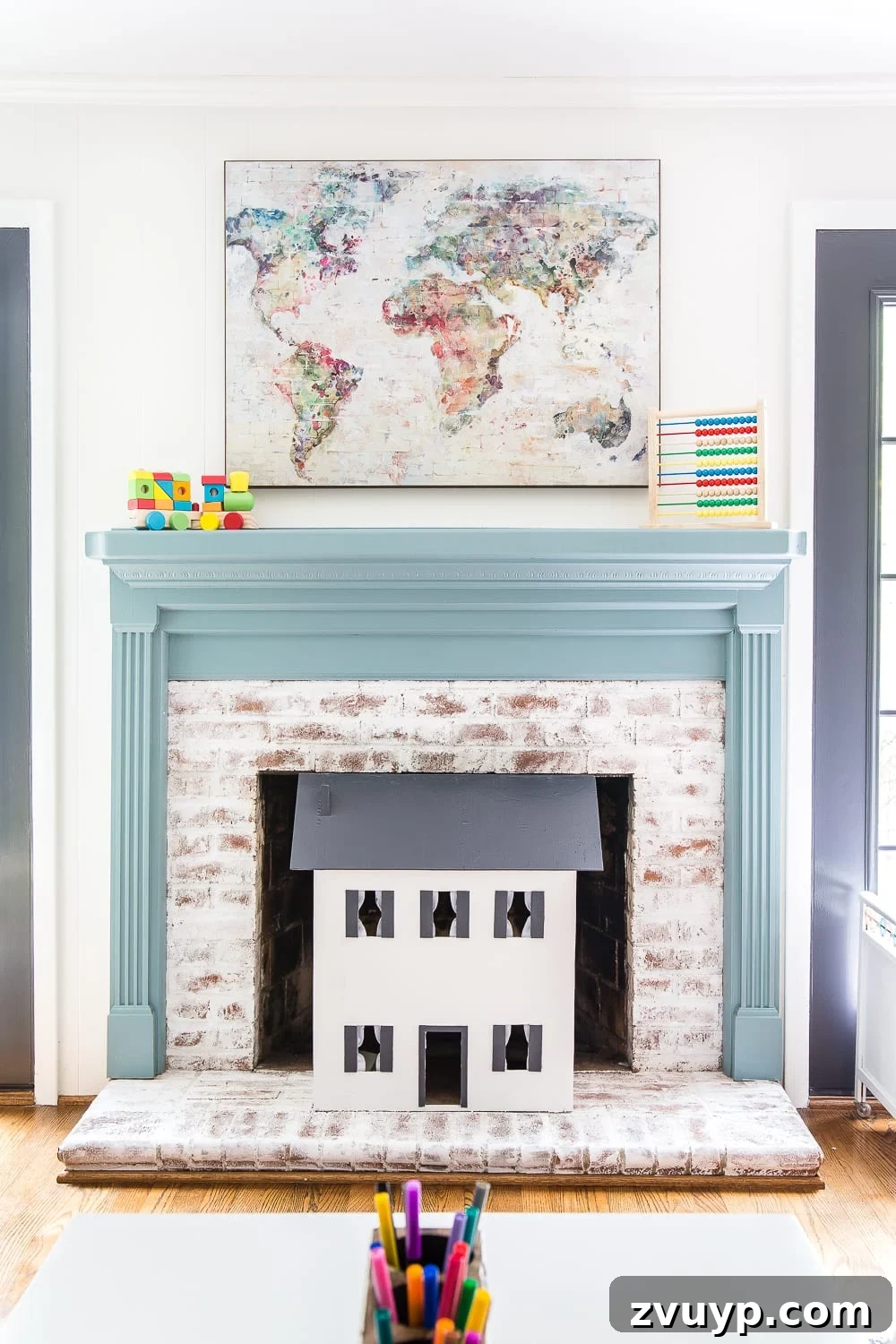 Kids Dream Playroom Revealed 6 Bright and organized playroom corner with lime washed fireplace, showcasing efficient toy storage solutions.