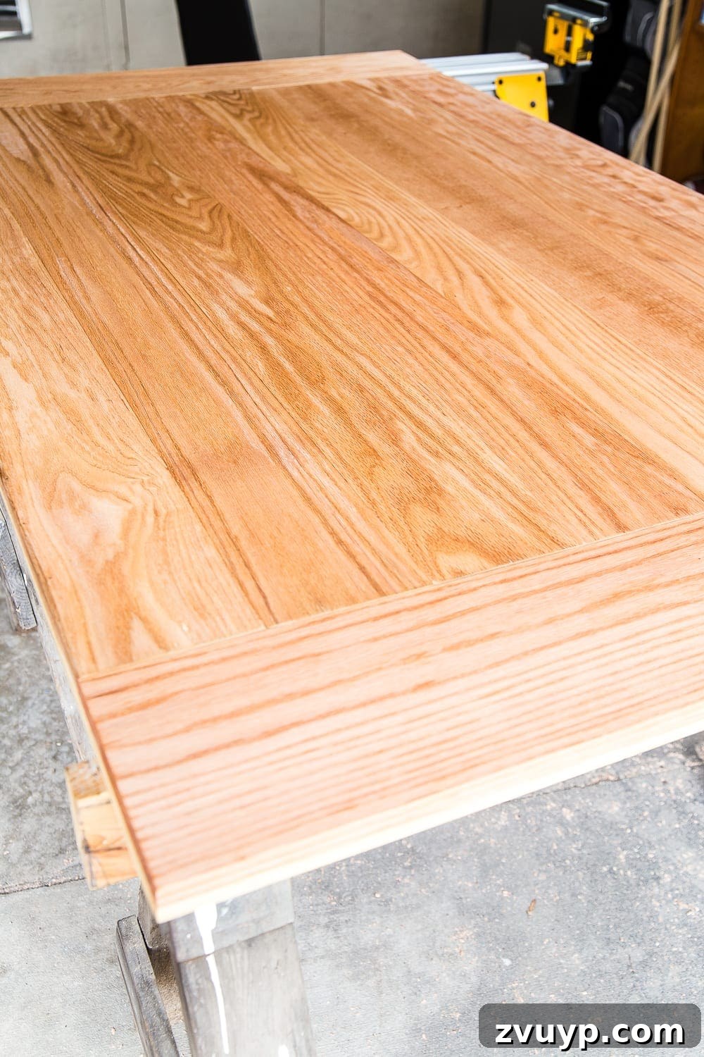 Revamping Your Dining Table Top 19 A tutorial for how to build a retrofitted table top to fit over any existing table using Minwax Dark Walnut stain. #build #furniturebuilding #tabletop #diningtable #diytable #farmhousetable #diyfurniture #woodworking #furnituremakeover #tablemakeover #minwax #woodstain #walnut