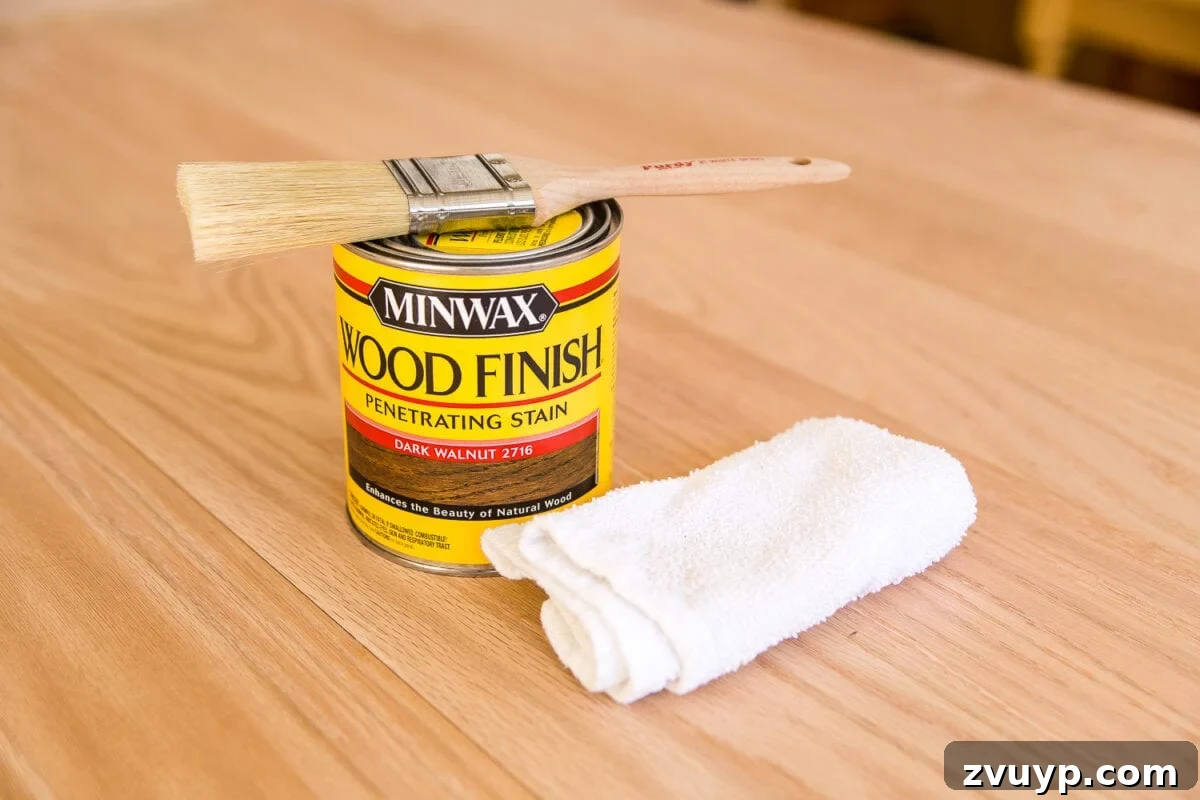 Revamping Your Dining Table Top 25 A tutorial for how to build a retrofitted table top to fit over any existing table using Minwax Dark Walnut stain. #build #furniturebuilding #tabletop #diningtable #diytable #farmhousetable #diyfurniture #woodworking #furnituremakeover #tablemakeover #minwax #woodstain #walnut