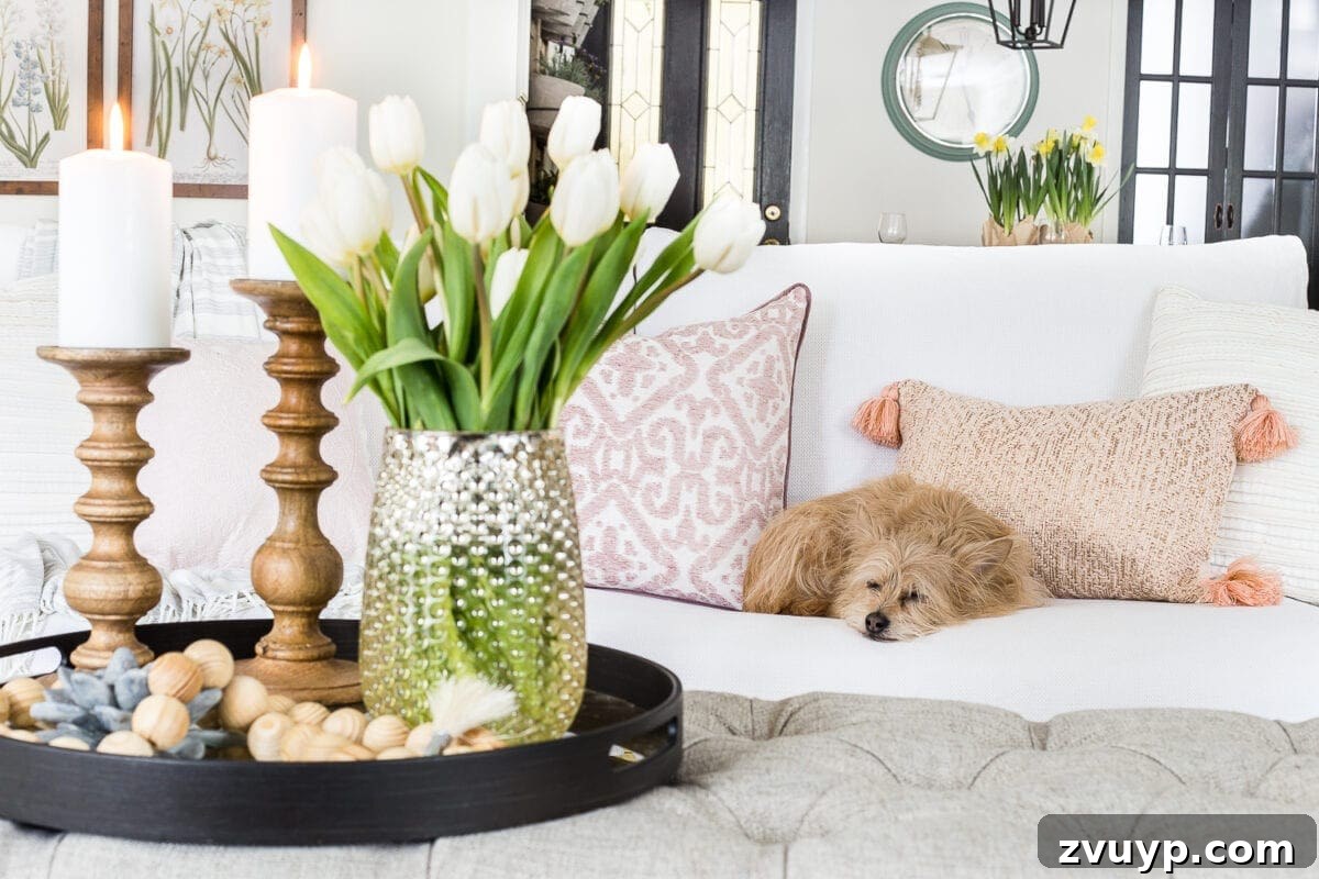 Spring Living Room Refresh 4 A living room gets a spring refresh with simple florals, candle light, and light fabrics. #springdecor #living room #springlivingroom #springaccents #livingroomdesign #livingroomdecor #budgetdecor
