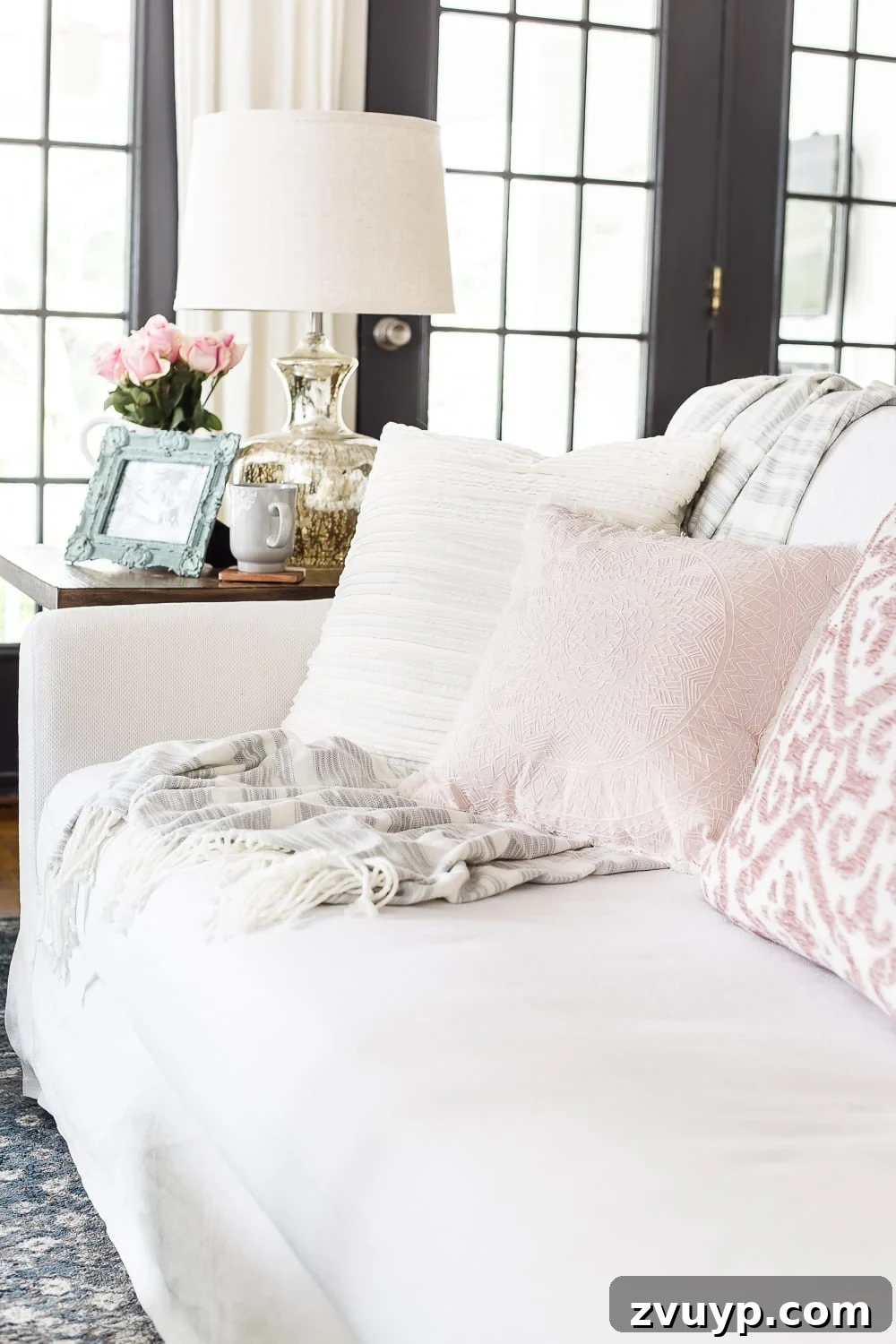 Spring Living Room Refresh 7 A living room gets a spring refresh with simple florals, candle light, and light fabrics. #springdecor #living room #springlivingroom #springaccents #livingroomdesign #livingroomdecor #budgetdecor