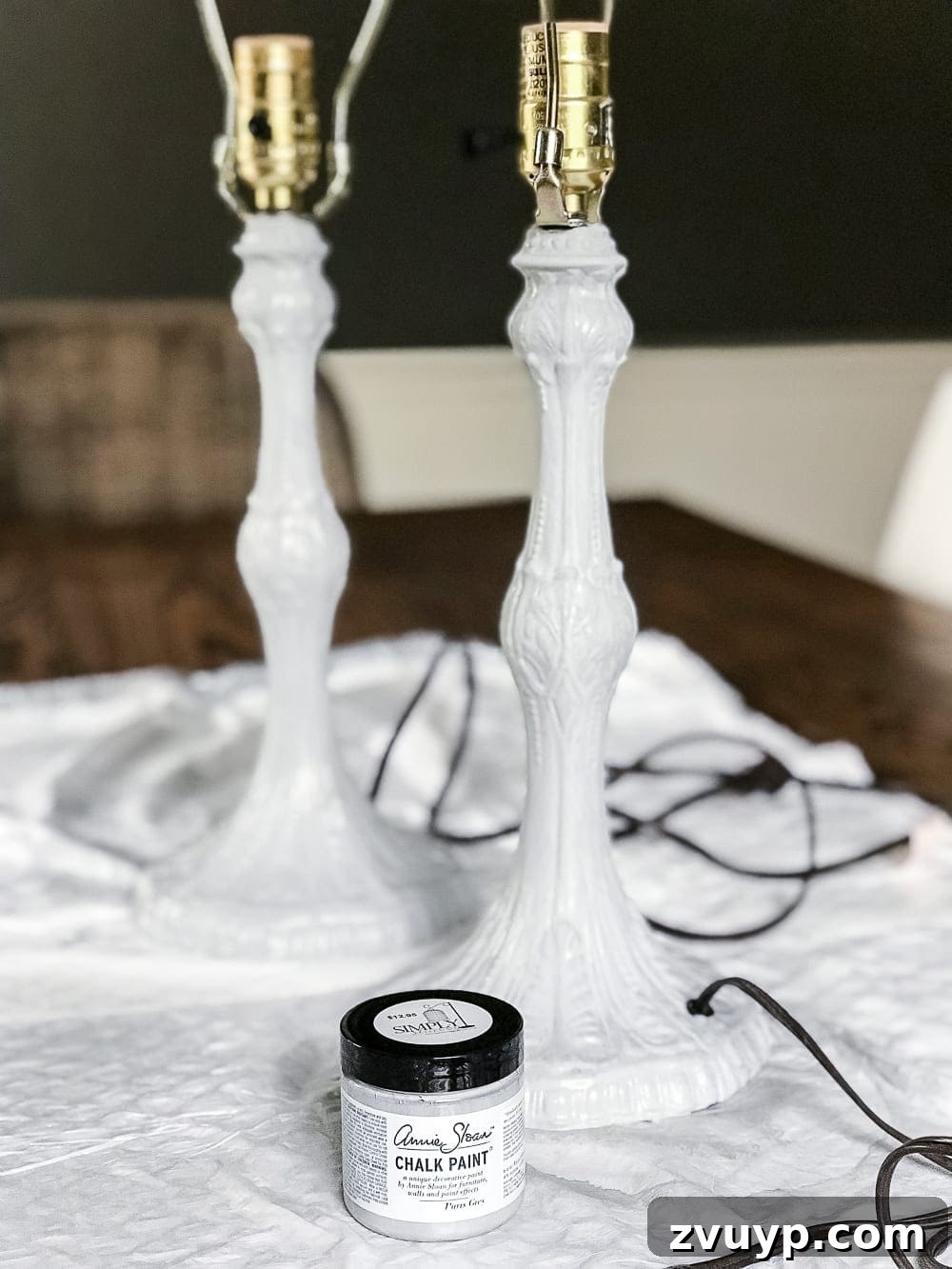 A thrifted table lamp gets a French Baroque designer inspired makeover using Annie Sloan Chalk Paint in Paris Grey, Pure White, clear wax, and dark wax. #thriftdecor #thrifted #thrifting #thriftmakeover #lamp #bedroom #girlbedroom #littlegirlbedroom #frenchdecor #femininedecor #designerknockoff #designerdecor 