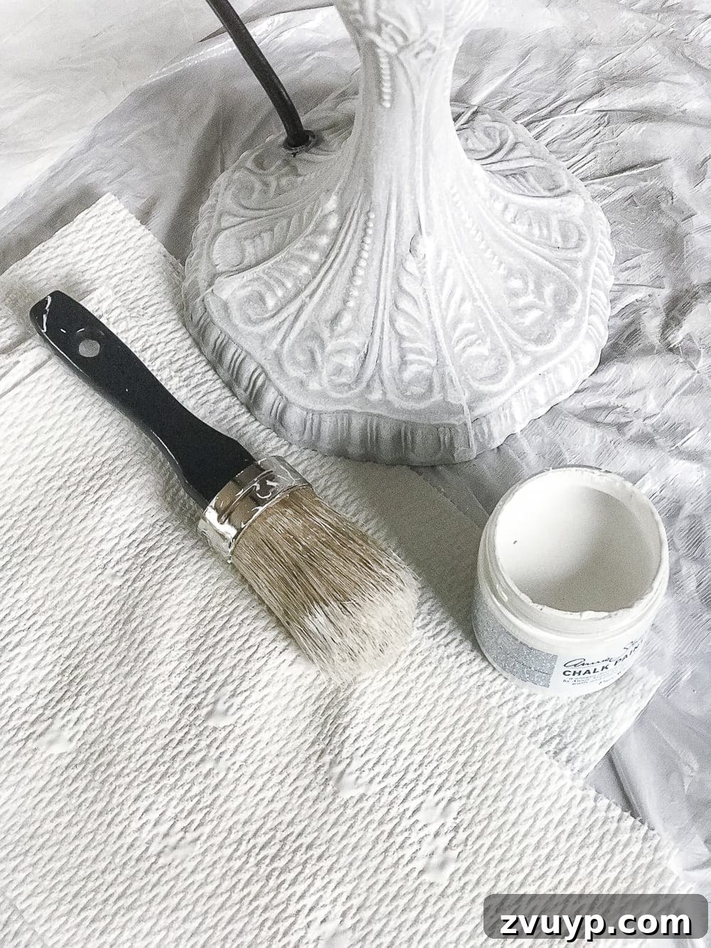 A thrifted table lamp gets a French Baroque designer inspired makeover using Annie Sloan Chalk Paint in Paris Grey, Pure White, clear wax, and dark wax. #thriftdecor #thrifted #thrifting #thriftmakeover #lamp #bedroom #girlbedroom #littlegirlbedroom #frenchdecor #femininedecor #designerknockoff #designerdecor 