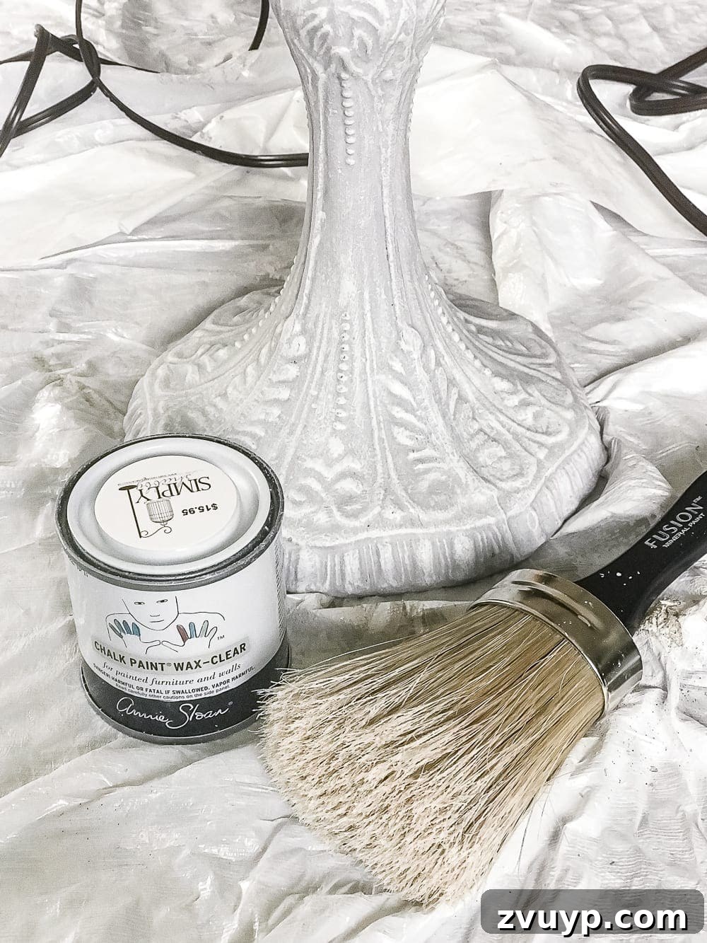 A thrifted table lamp gets a French Baroque designer inspired makeover using Annie Sloan Chalk Paint in Paris Grey, Pure White, clear wax, and dark wax. #thriftdecor #thrifted #thrifting #thriftmakeover #lamp #bedroom #girlbedroom #littlegirlbedroom #frenchdecor #femininedecor #designerknockoff #designerdecor 