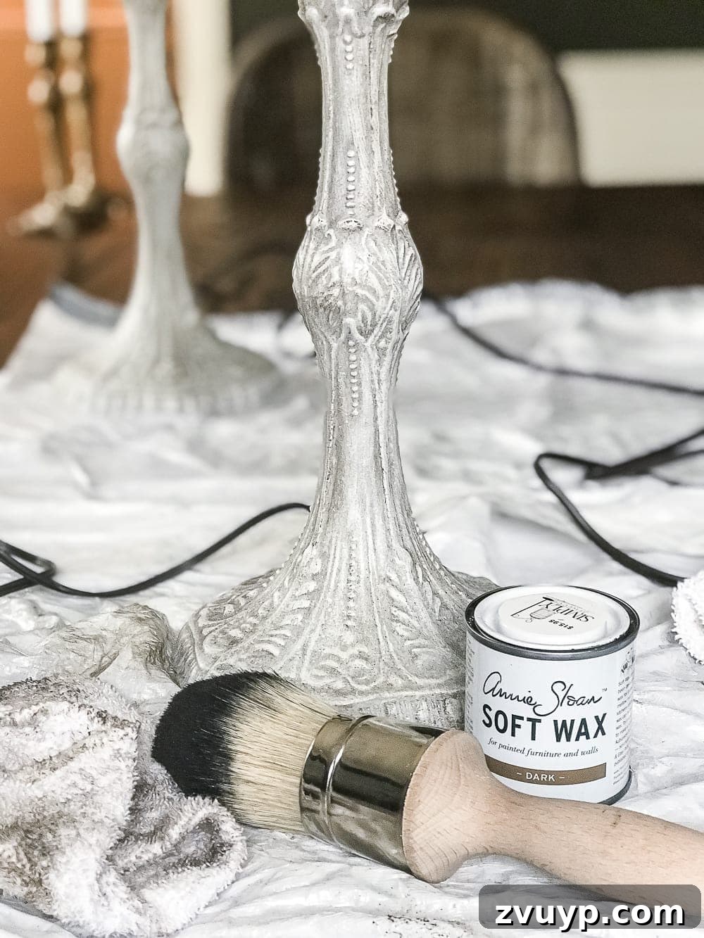 A thrifted table lamp gets a French Baroque designer inspired makeover using Annie Sloan Chalk Paint in Paris Grey, Pure White, clear wax, and dark wax. #thriftdecor #thrifted #thrifting #thriftmakeover #lamp #bedroom #girlbedroom #littlegirlbedroom #frenchdecor #femininedecor #designerknockoff #designerdecor 