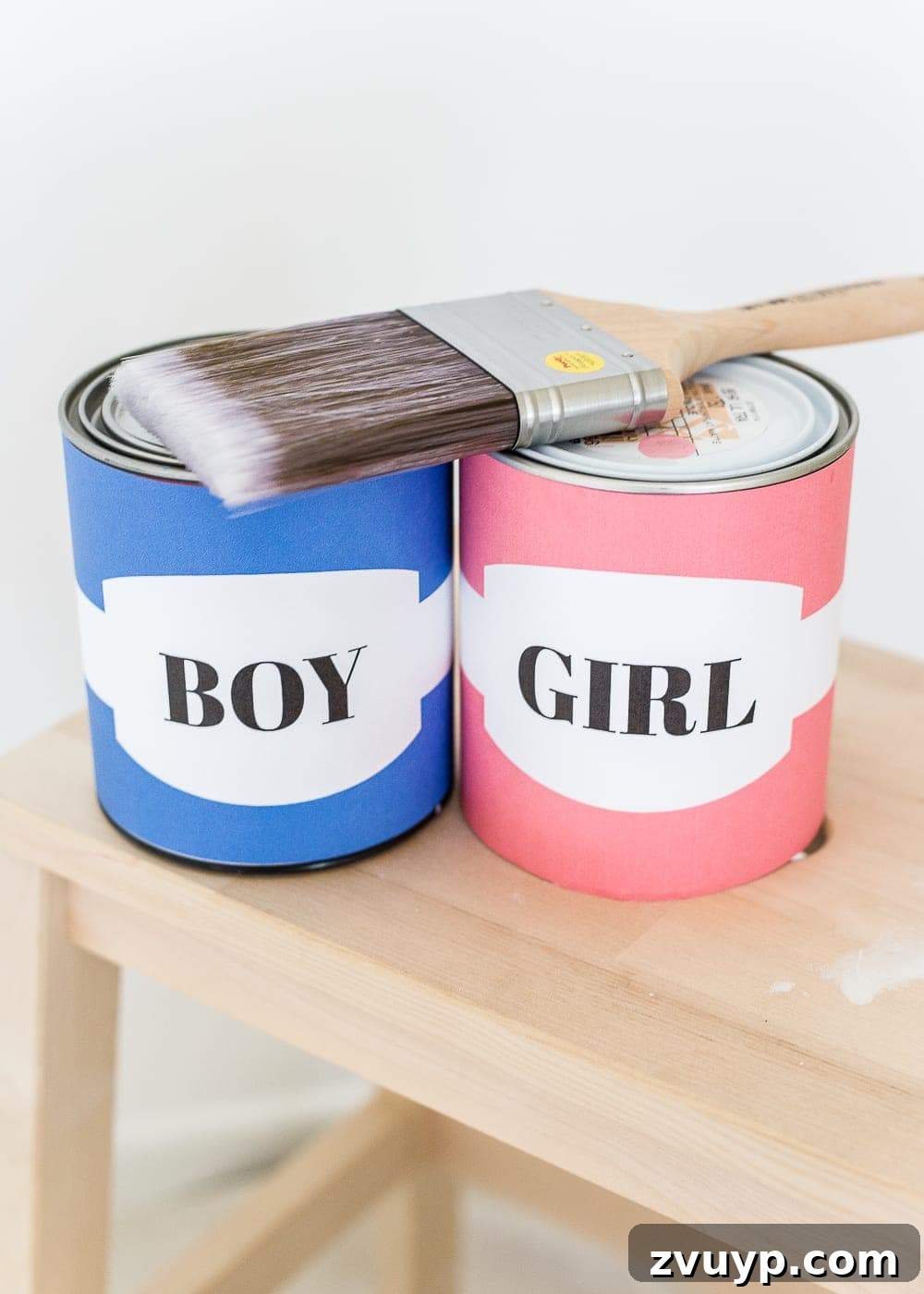 Expecting mother holding a paintbrush, ready for a DIY gender reveal using wall paint in the nursery. #genderreveal #heorshe #boyorgirl #nursery #genderphotoshoot #DIYgenderreveal