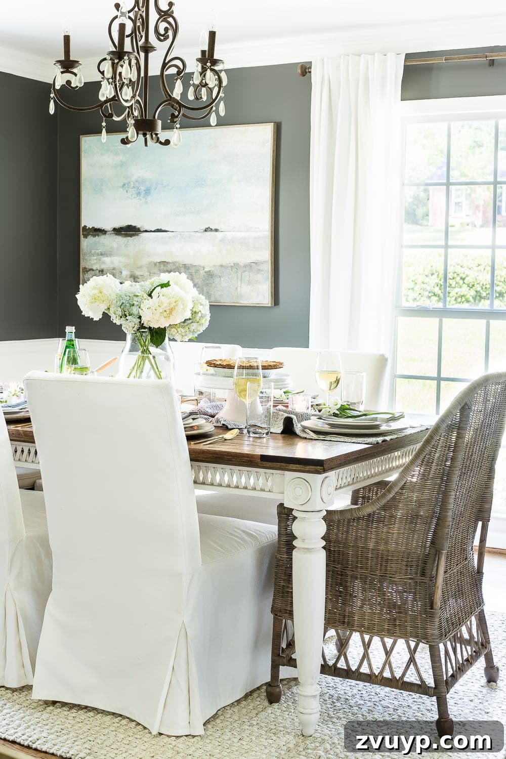 Inspiring Summer Homes 2018 14 Overall view of a beautifully styled Mother's Day tablescape in a dining room with a classic aesthetic, featuring natural light and warm textures. #mothersdaystyle #classicdining #naturaldecor #warminteriors #summerevent #1960scolonialhome