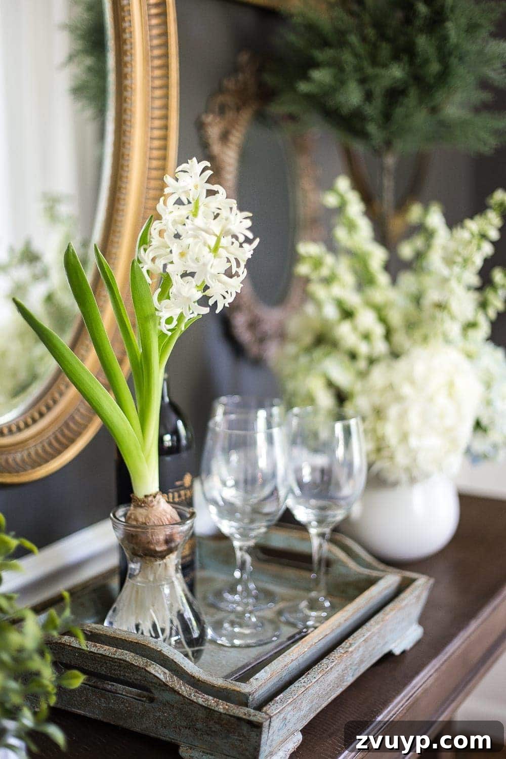 Inspiring Summer Homes 2018 16 Detailed view of a collection of antique mirrors making up a gallery wall in a dining room, reflecting the classic and neutral decor of the 1960 colonial home. #antiquedecor #mirrordisplay #gallerywallideas #classicneutral #summertourblog #homedesign