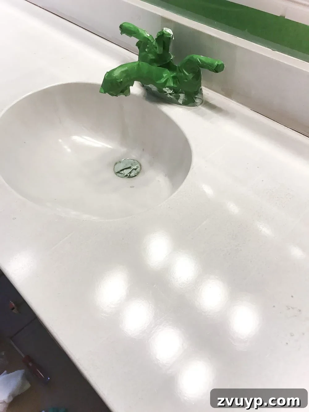 Our Painted Bathroom Sink, Counter, Tub, Shower An 8-Month Durability Update 5 Applying the first coat of Rust-Oleum Tub & Tile Refinishing Kit, showing the initial appearance of the DIY painted sink and countertop.