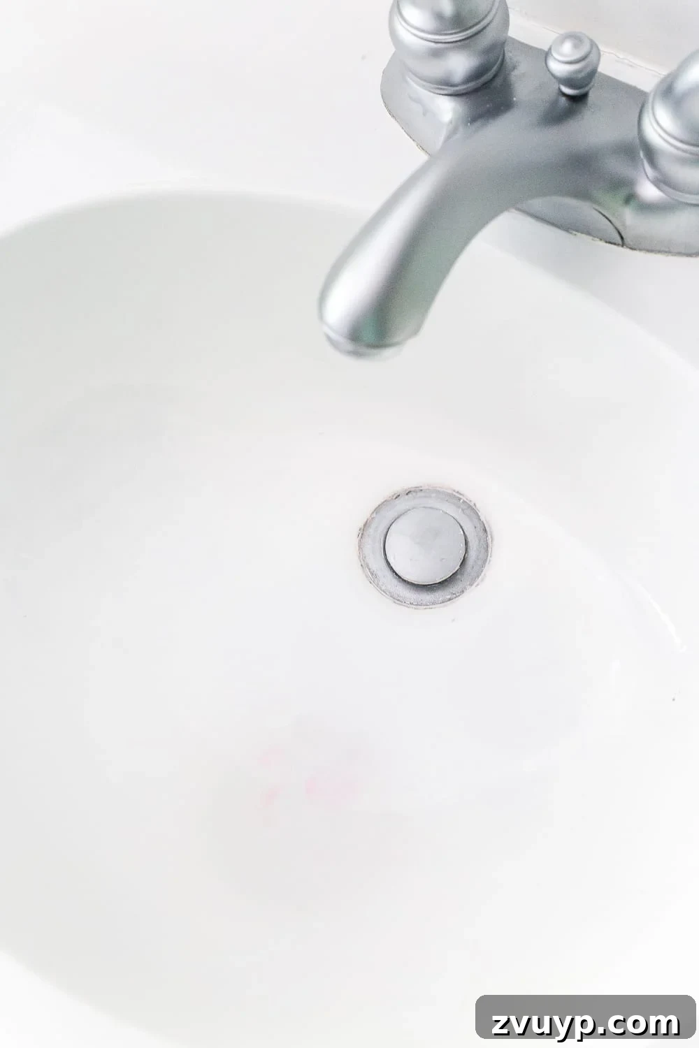 Our Painted Bathroom Sink, Counter, Tub, Shower An 8-Month Durability Update 10 Close-up of the painted sink, showing a minor pink toothpaste stain and explaining the cause and preventative measures for refinished surfaces.