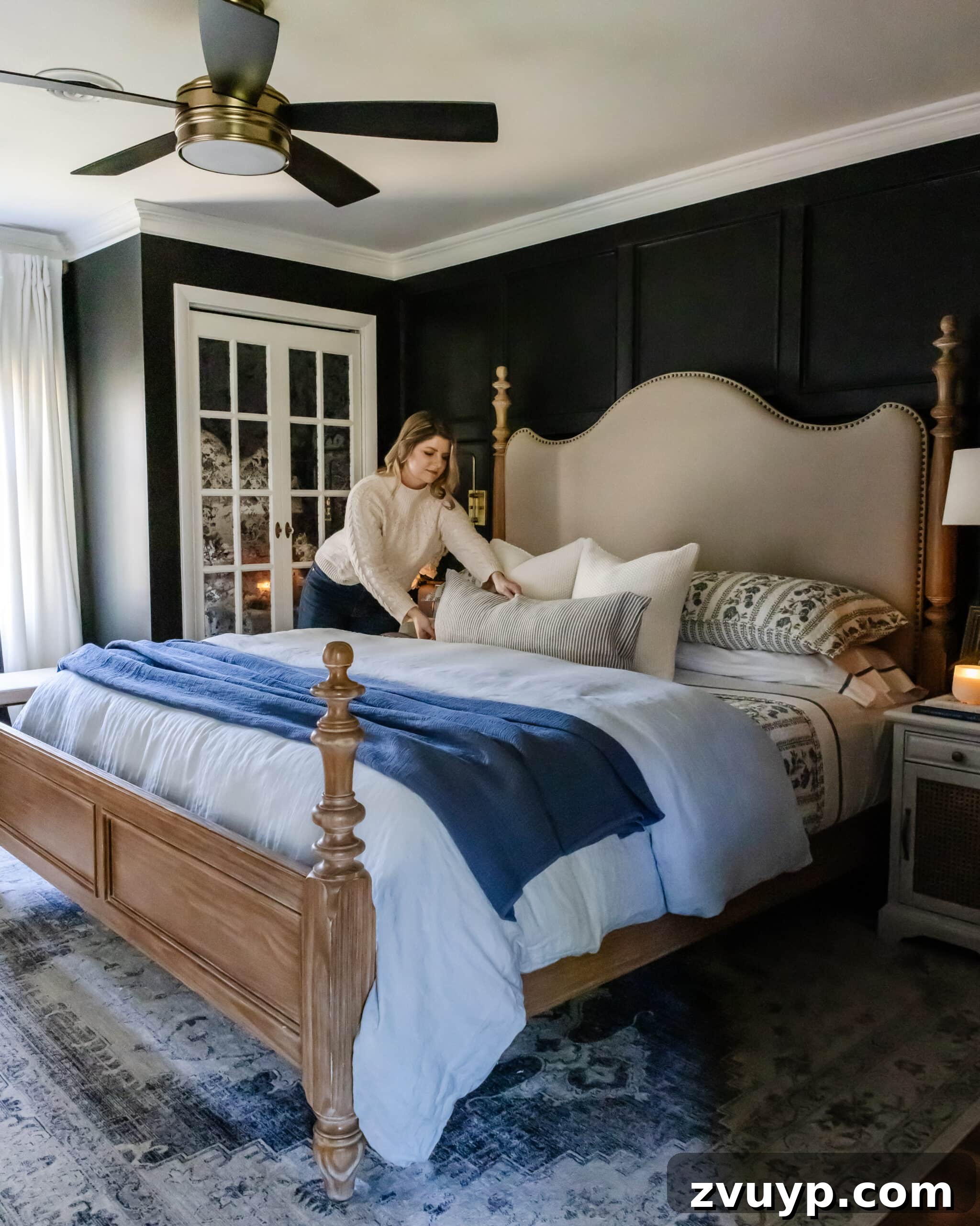 Master the Magazine Worthy Bed 2 A beautifully made bed in a cozy bedroom, featuring layers of white bedding and decorative pillows, creating a hotel-like appearance.