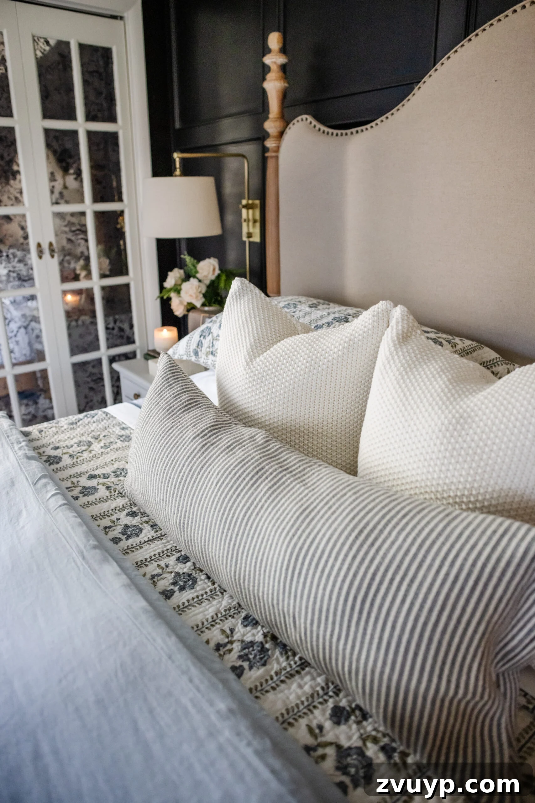 Master the Magazine Worthy Bed 13 A bed adorned with multiple decorative pillows in varying sizes and textures, creating a luxurious and inviting display.